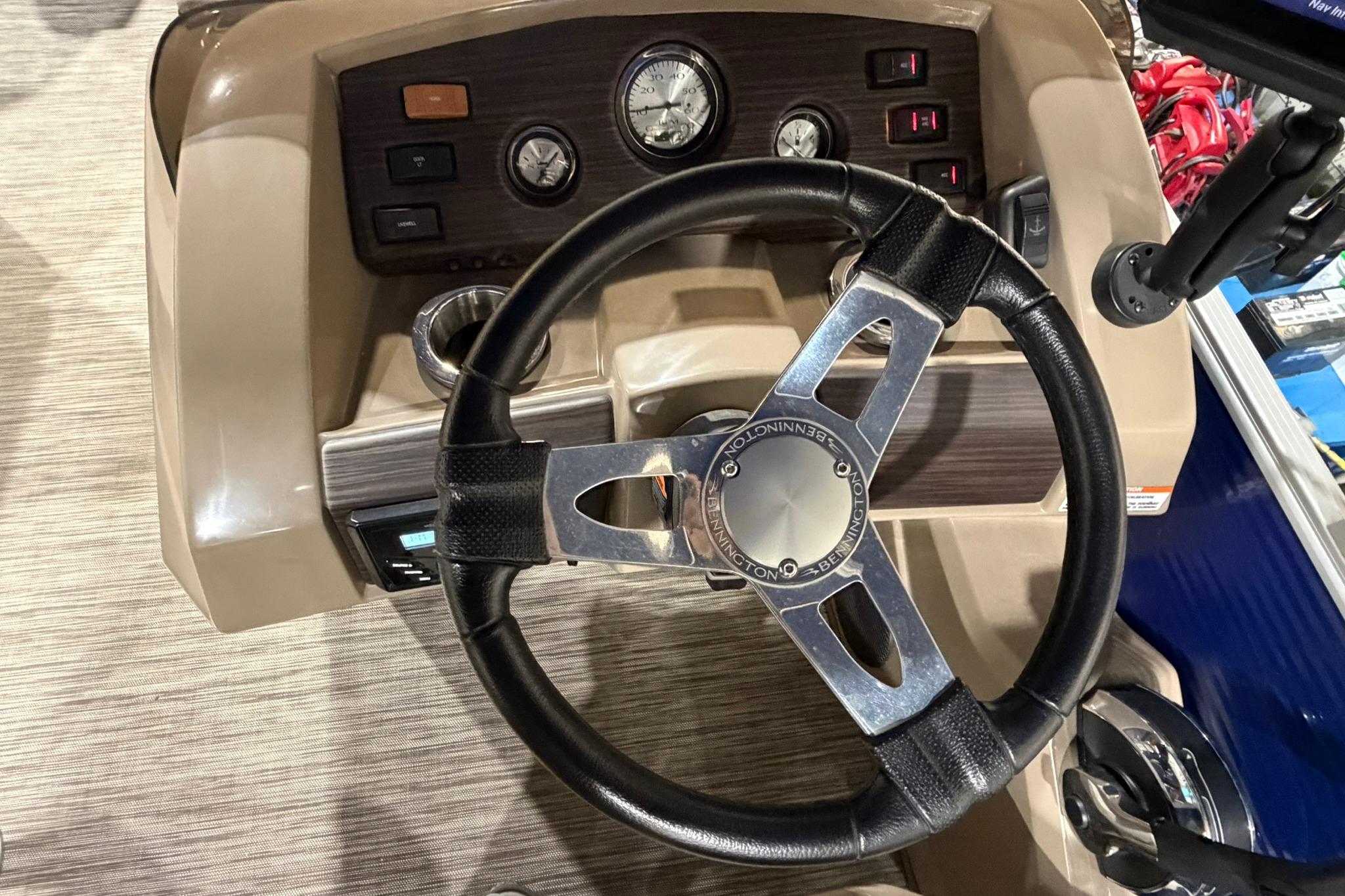Steering wheel and dashboard of 2020 Bennington SX 22 SFX boat, featuring gauges and controls.