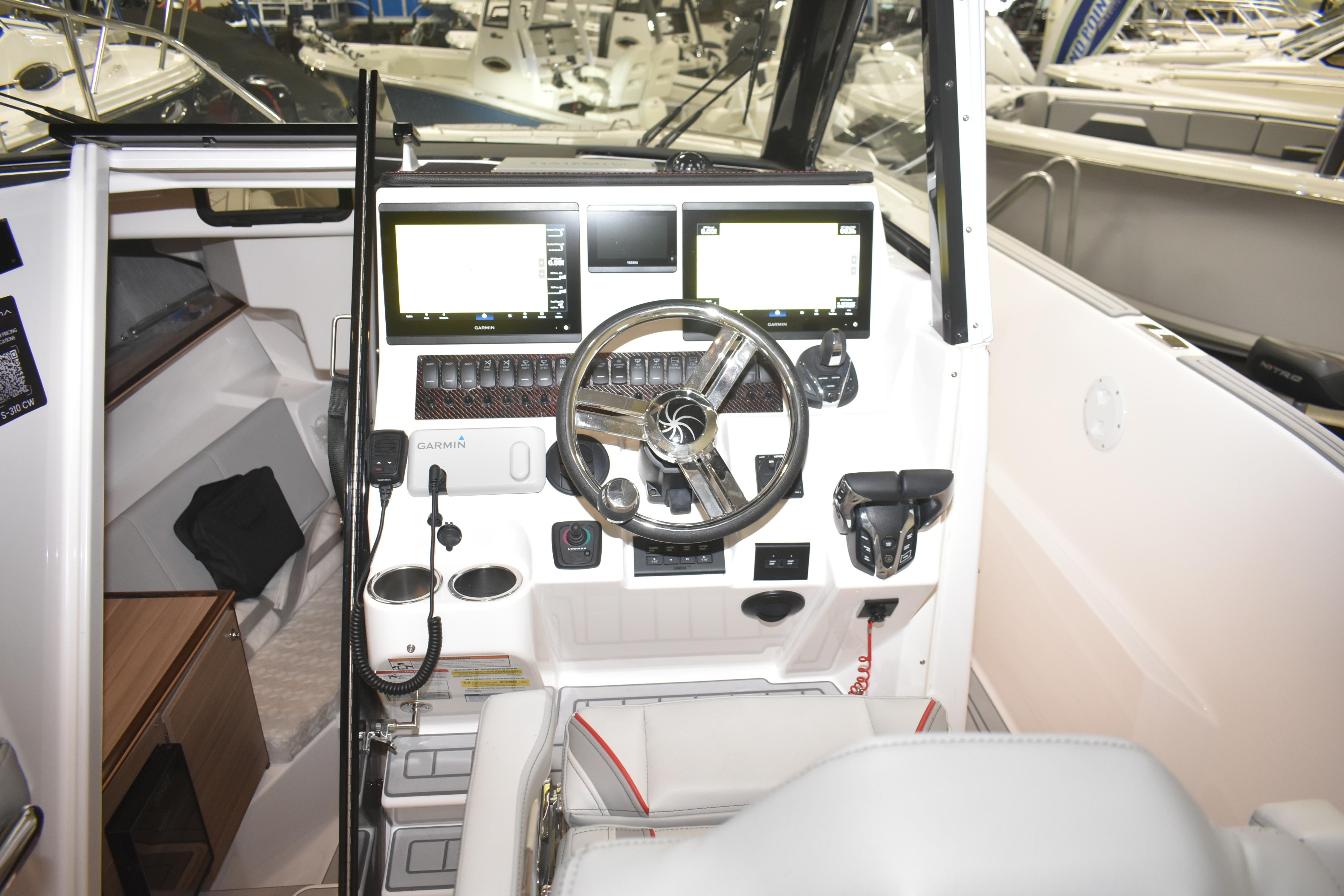 Helm of 2025 Solara S-310 CW boat with modern navigation displays and controls.