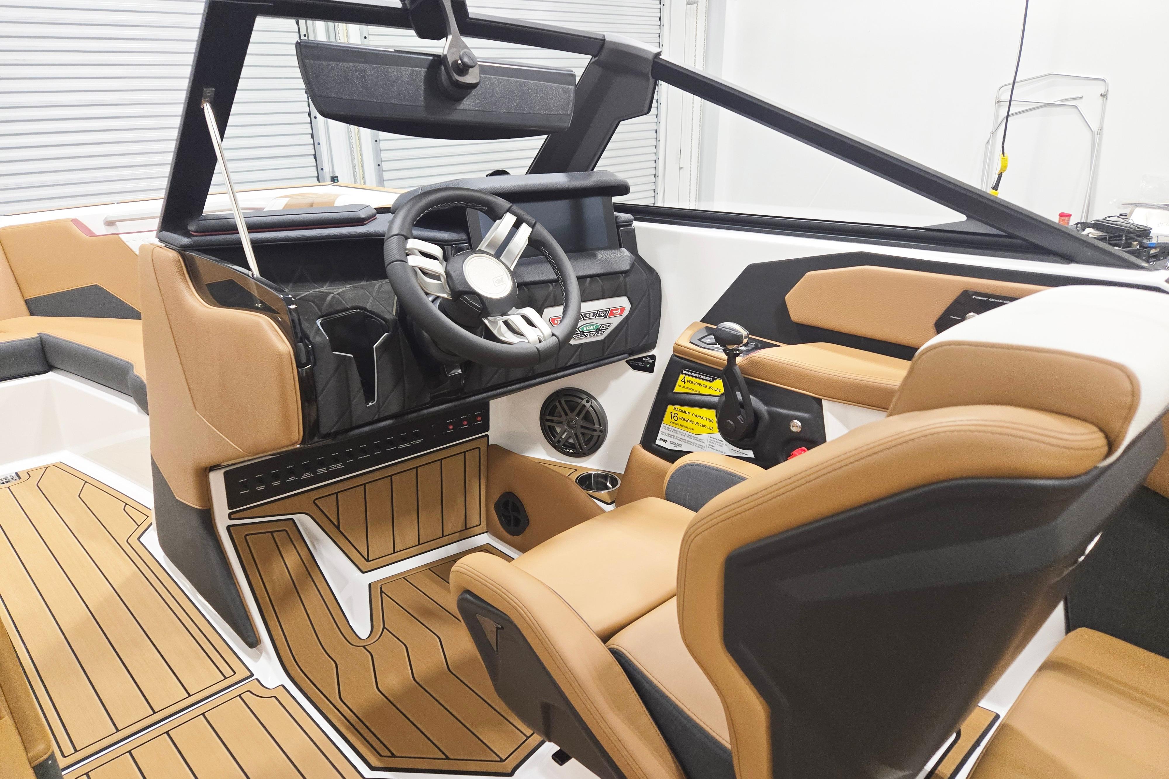 Interior of 2026 Nautique Super Air Nautique S23, featuring modern helm and luxurious seating.