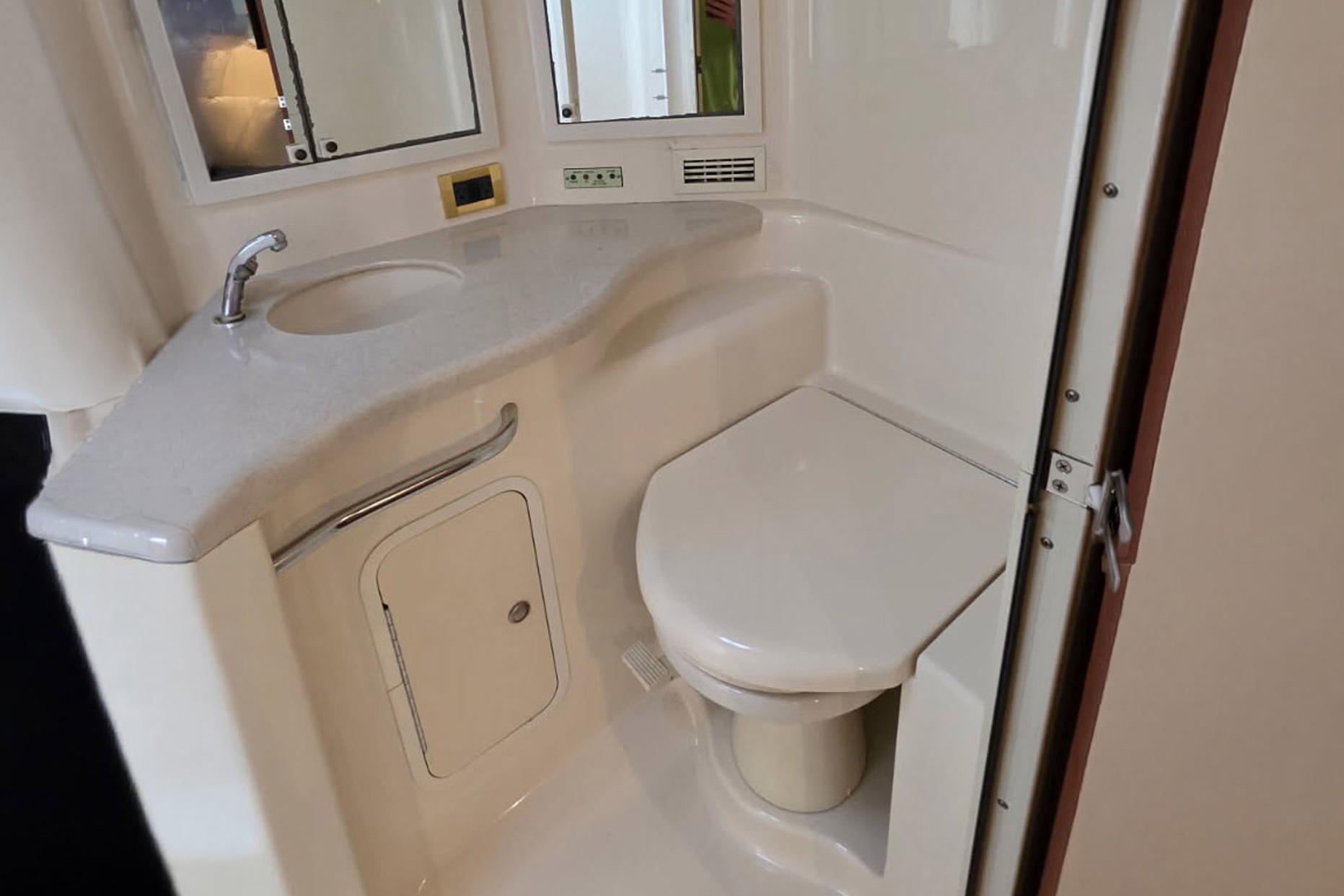 Bathroom interior of 1998 Sea Ray Sundancer 400 yacht with sink and toilet.