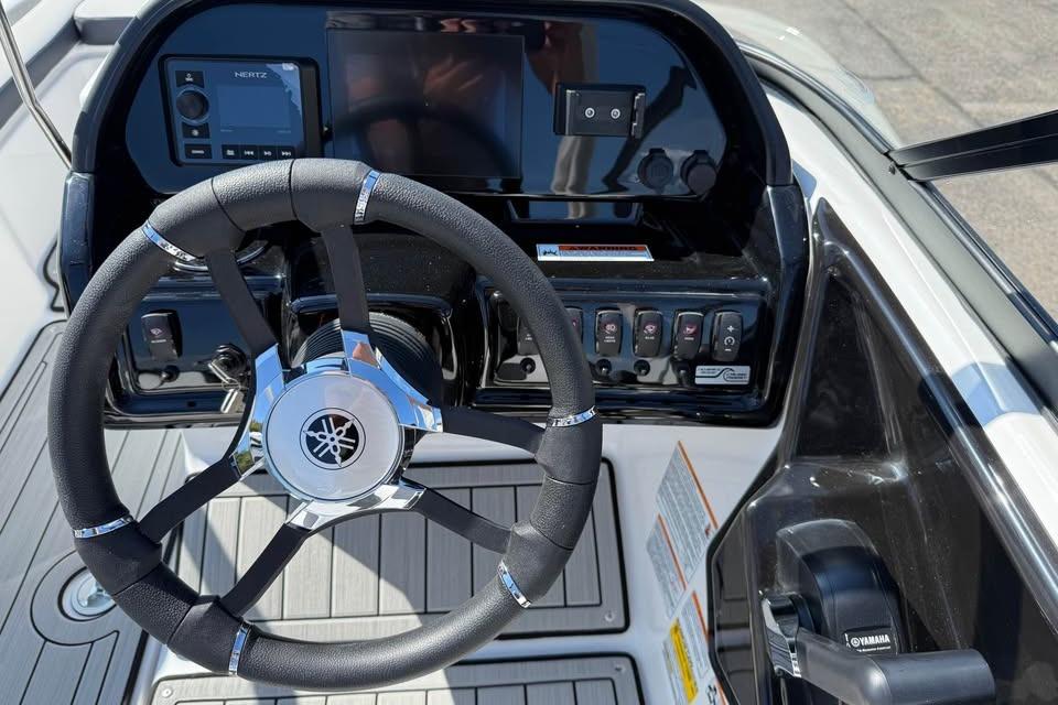 Steering console of 2026 Yamaha Boats 195S, featuring modern controls and sleek design.