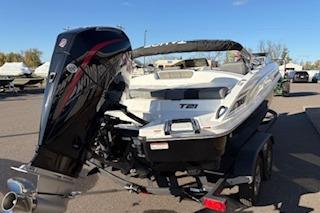 2026 Tahoe T21 boat on trailer, featuring powerful outboard motor, parked outdoors.