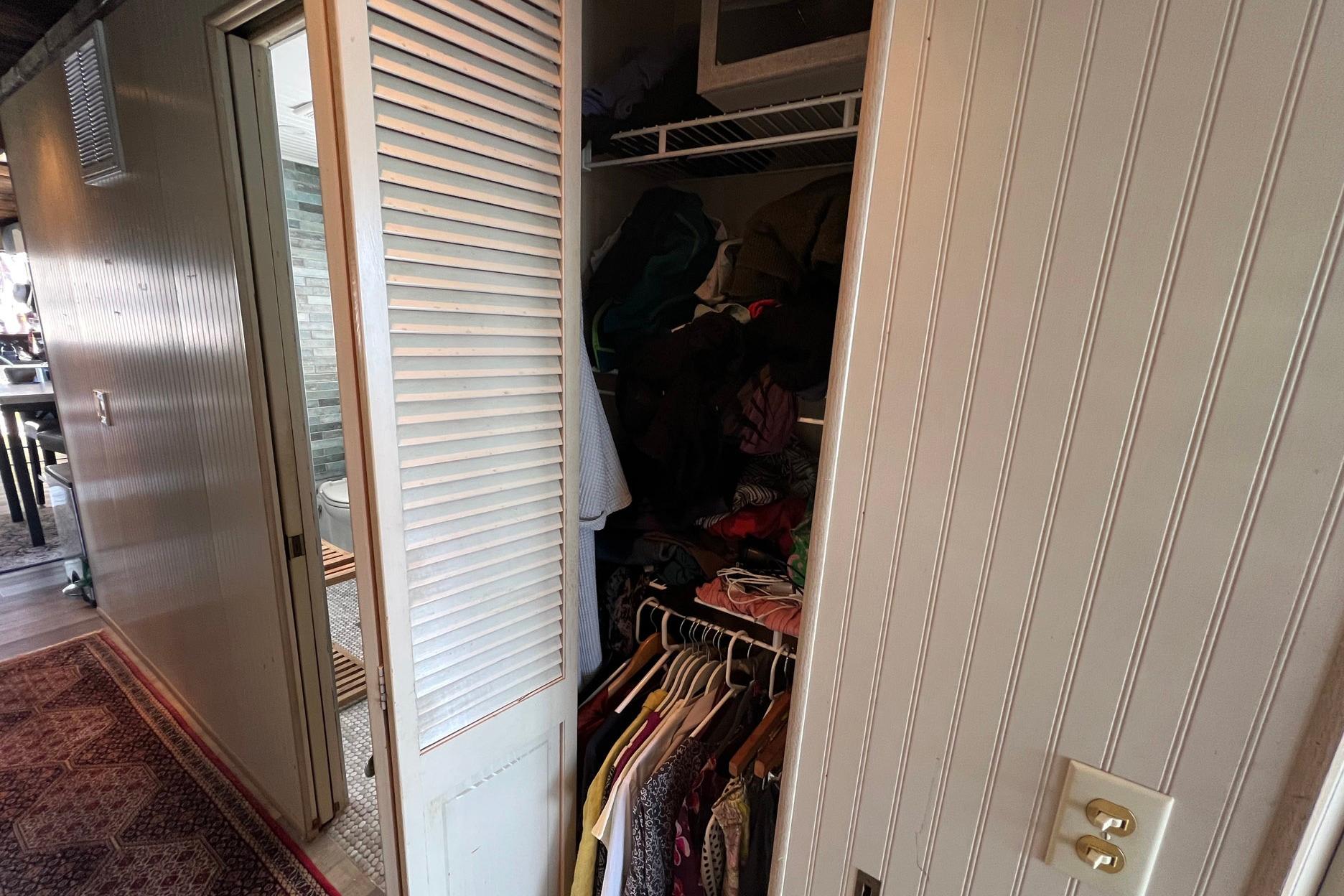 1993 Sumerset houseboat interior with open closet and visible bathroom.
