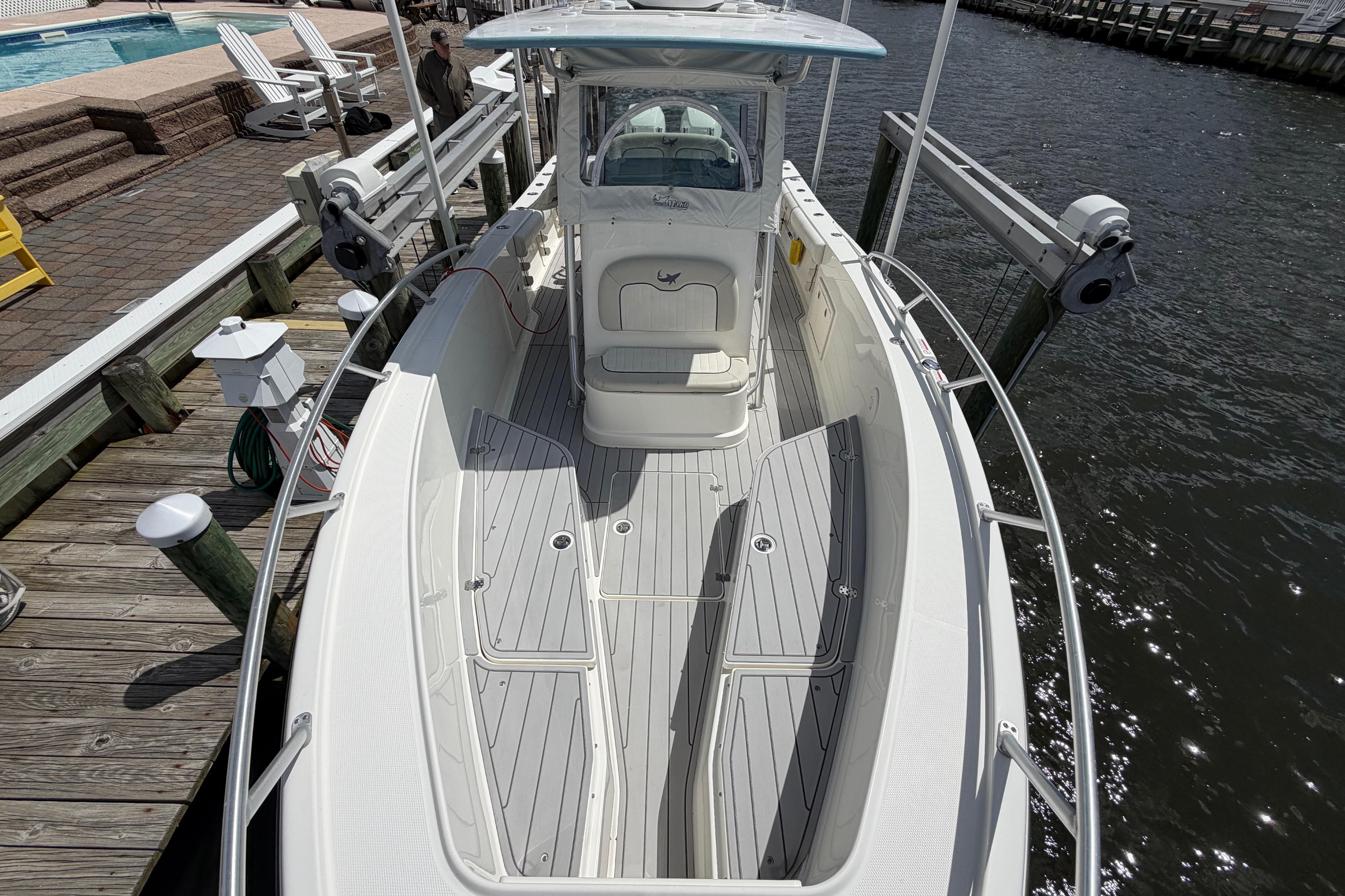 2017 Mako 284 Center Console boat docked by the water.