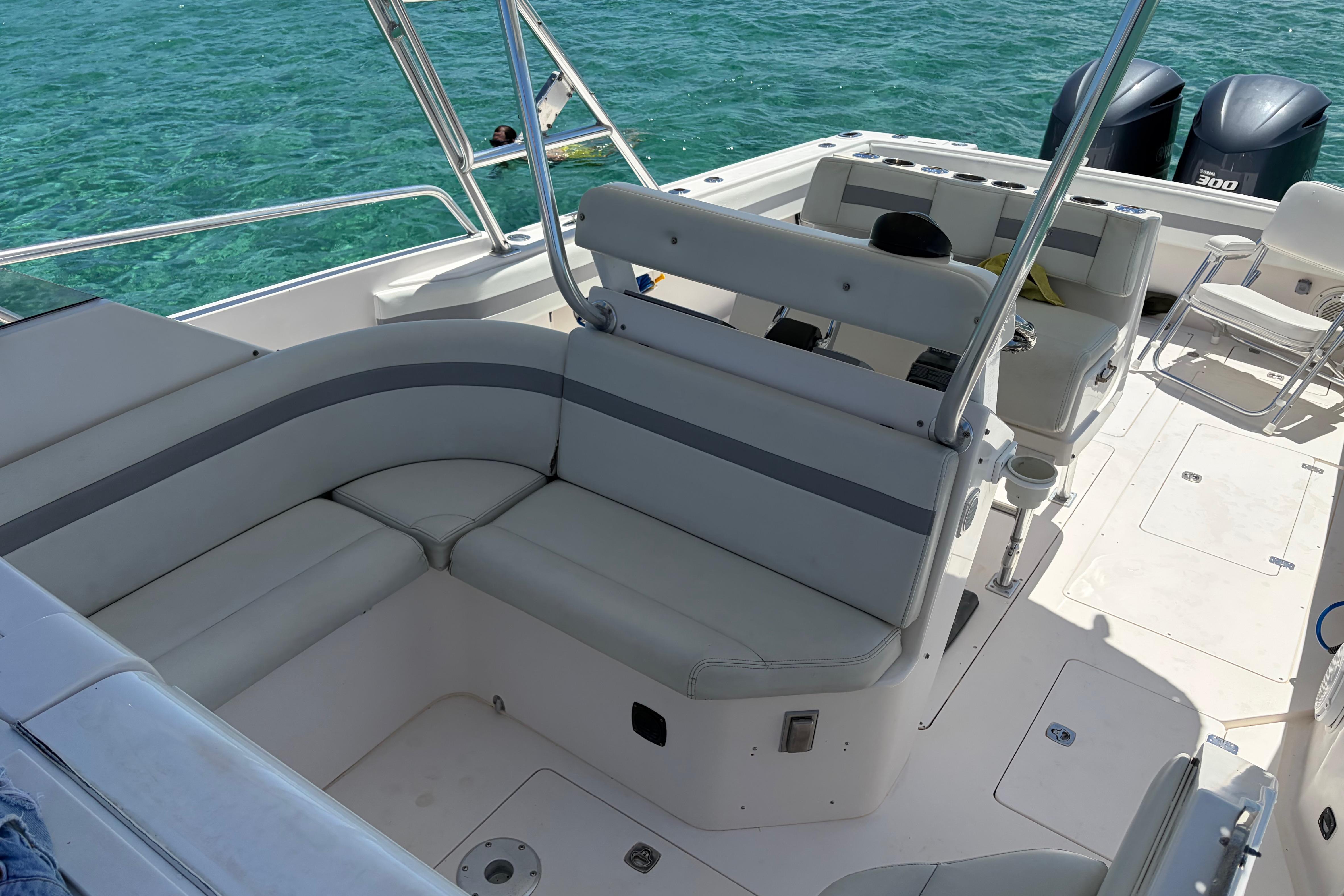 1998 Intrepid 339 Walkaround boat interior with seating, ocean backdrop, and dual engines.