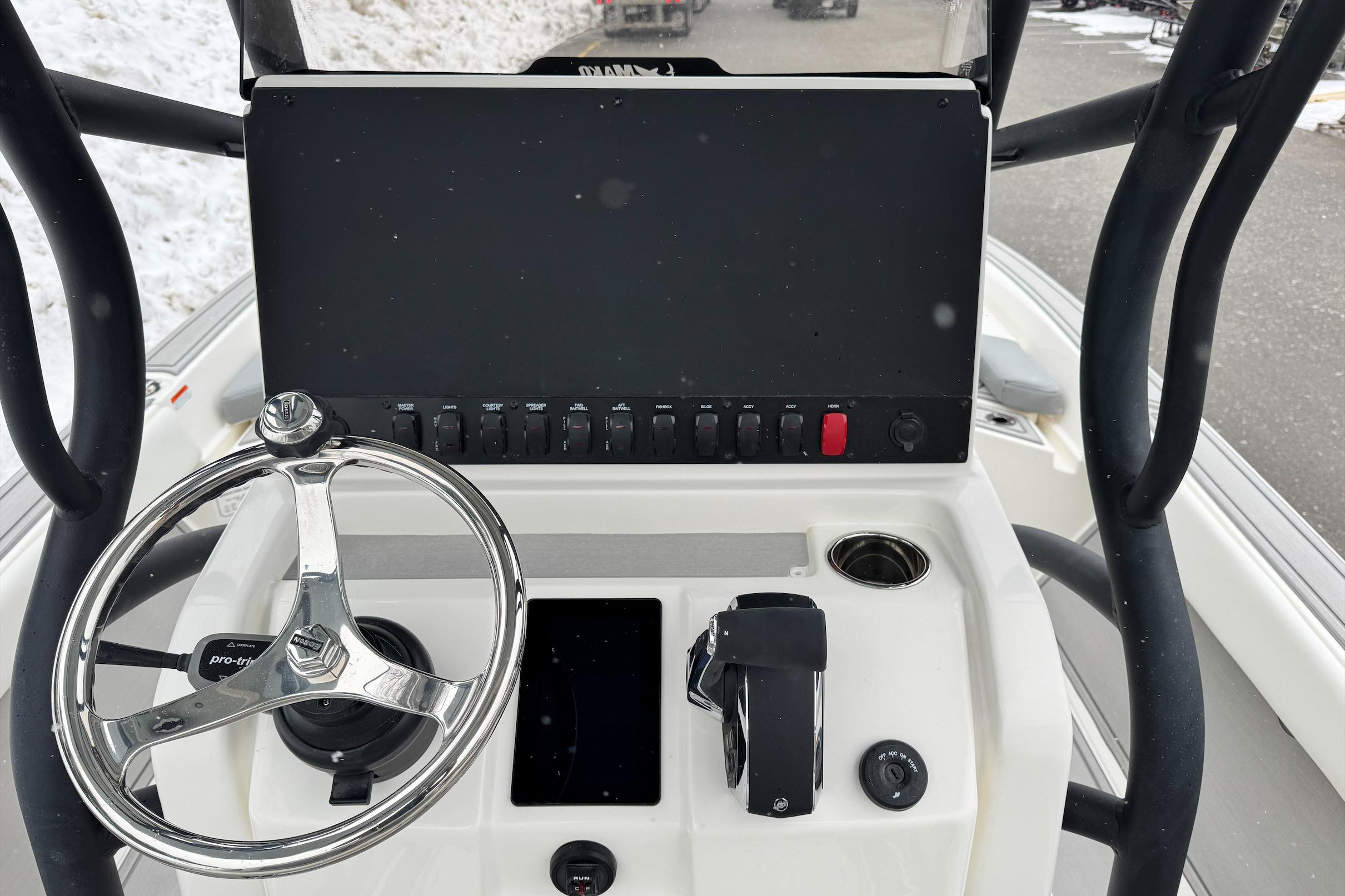 Steering console of 2026 Mako 24 APEX boat with modern controls and display.