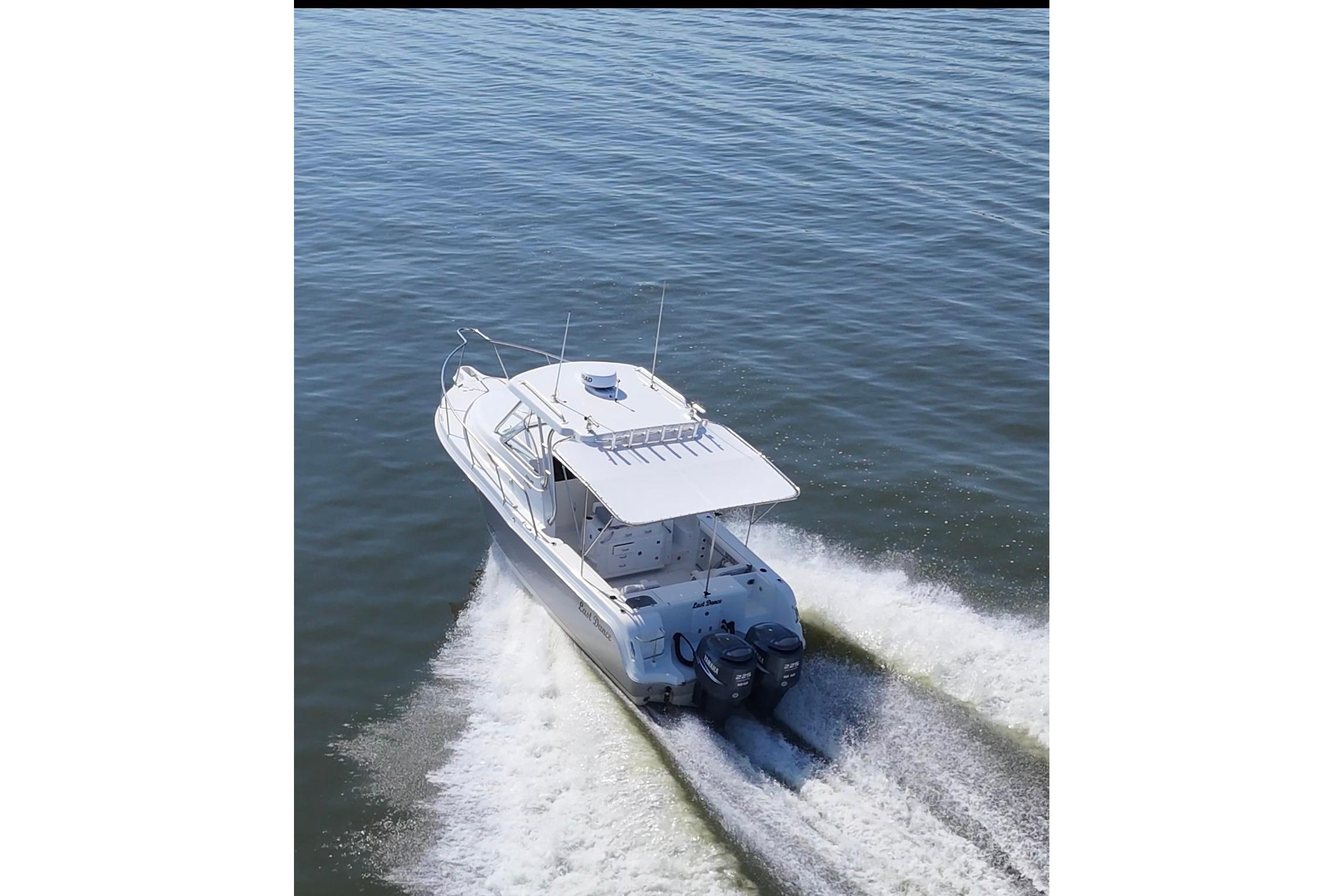 2007 Polar 2700 Walkaround boat cruising on open water, rear view.