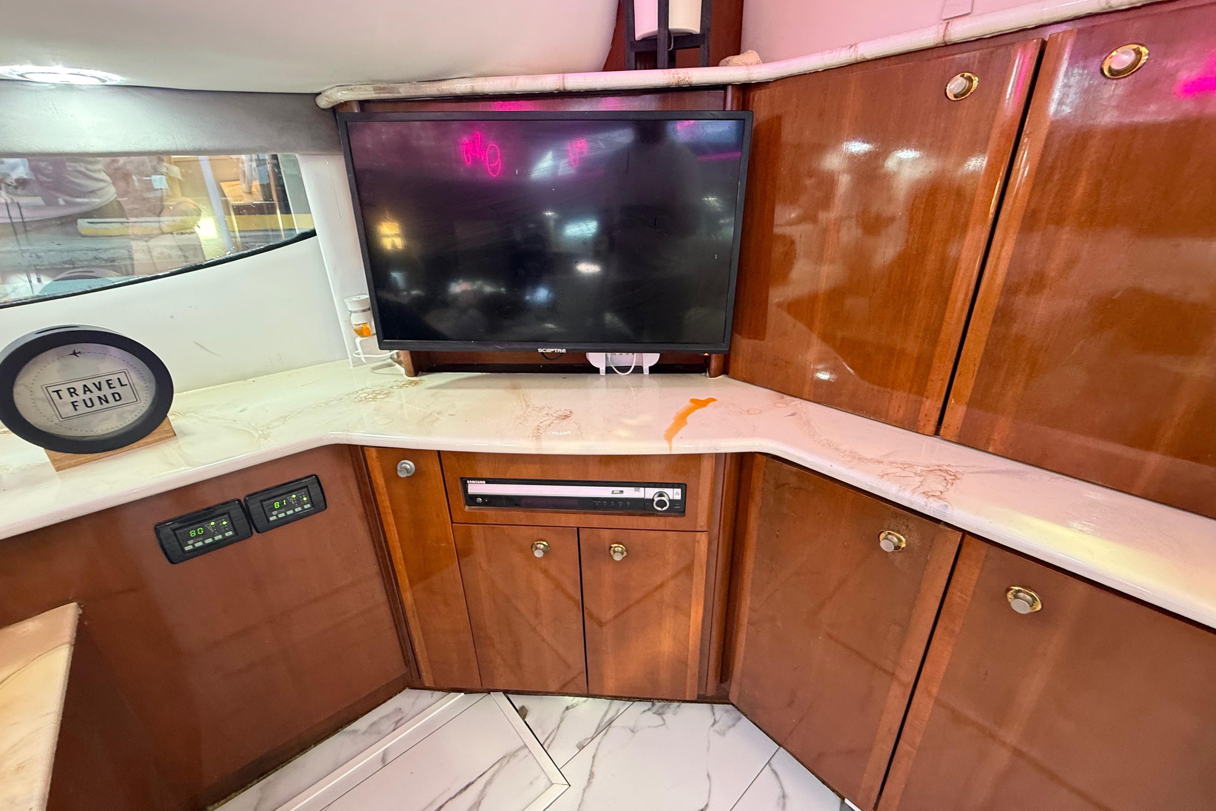 Luxurious interior of 2007 Meridian 459 Motoryacht with TV and wooden cabinetry.