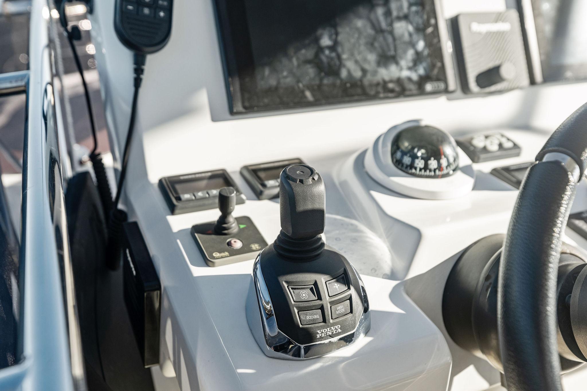 Control panel of a 2019 Prestige 520 yacht with joystick and compass.