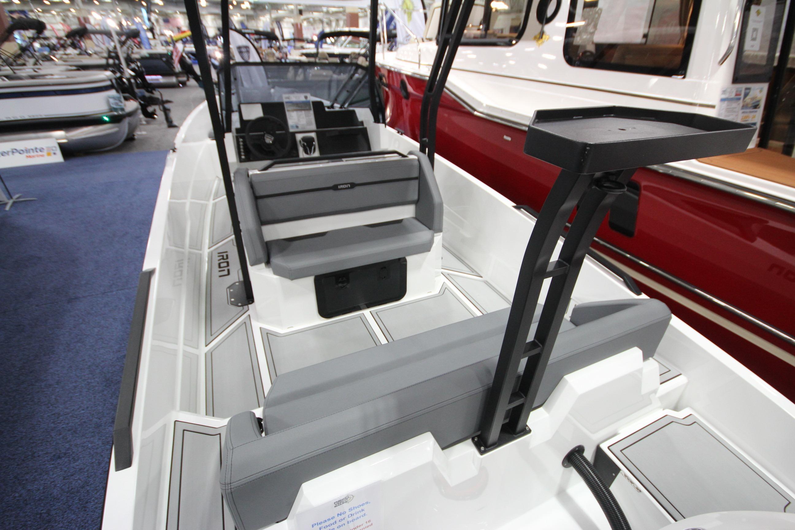 2026 Iron 827 T-Top boat interior at a boat show, featuring sleek seating and modern design.