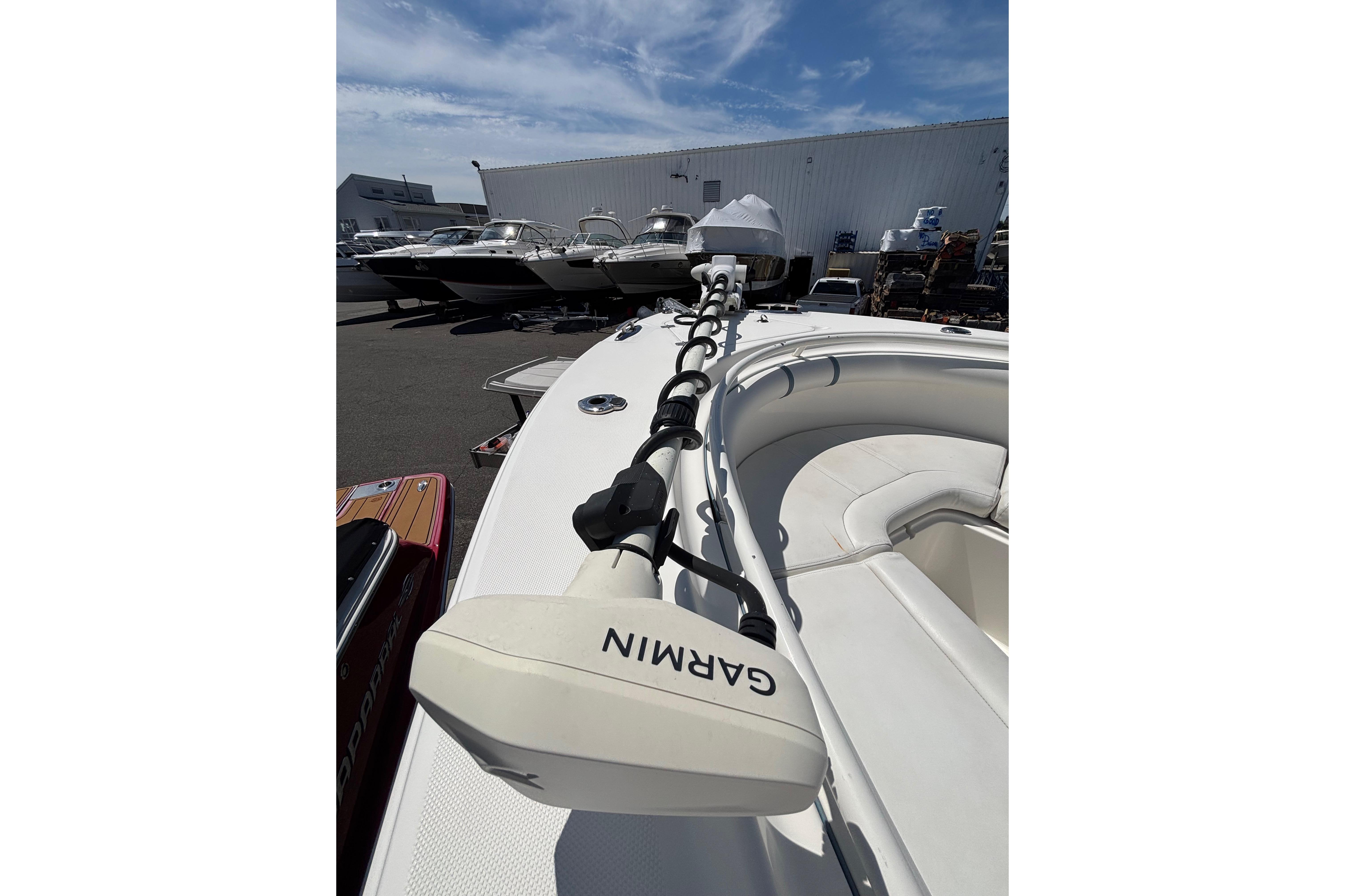 2006 Edgewater 318CC boat with Garmin equipment, docked among other boats.