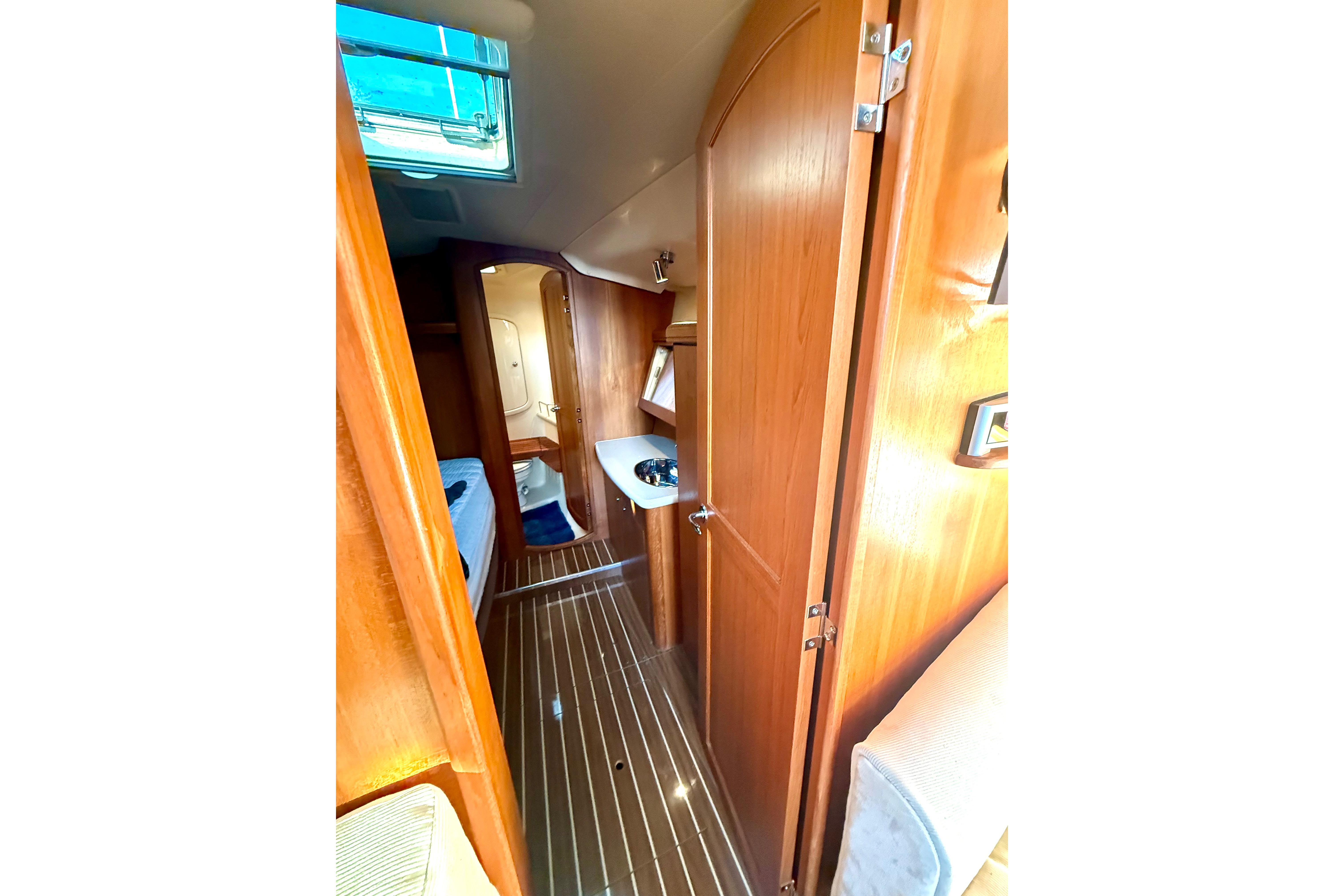 Interior view of 2007 Hunter 41 Deck Salon yacht, featuring wood paneling and modern amenities.