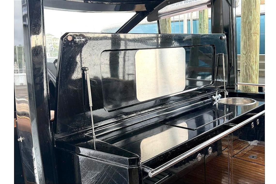 Outdoor kitchen area on a 2013 Windy SR52 yacht, featuring sleek black cabinetry.
