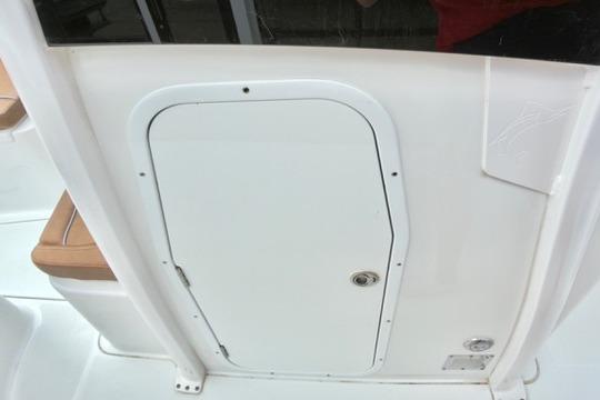 2026 Sea Hunt Ultra 255 SE boat hatch door, white with secure latch.