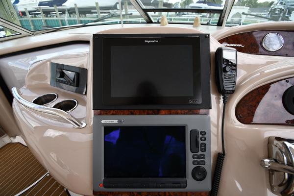 Control panel of 2003 Sea Ray 460 Sundancer yacht with navigation screens and radio.