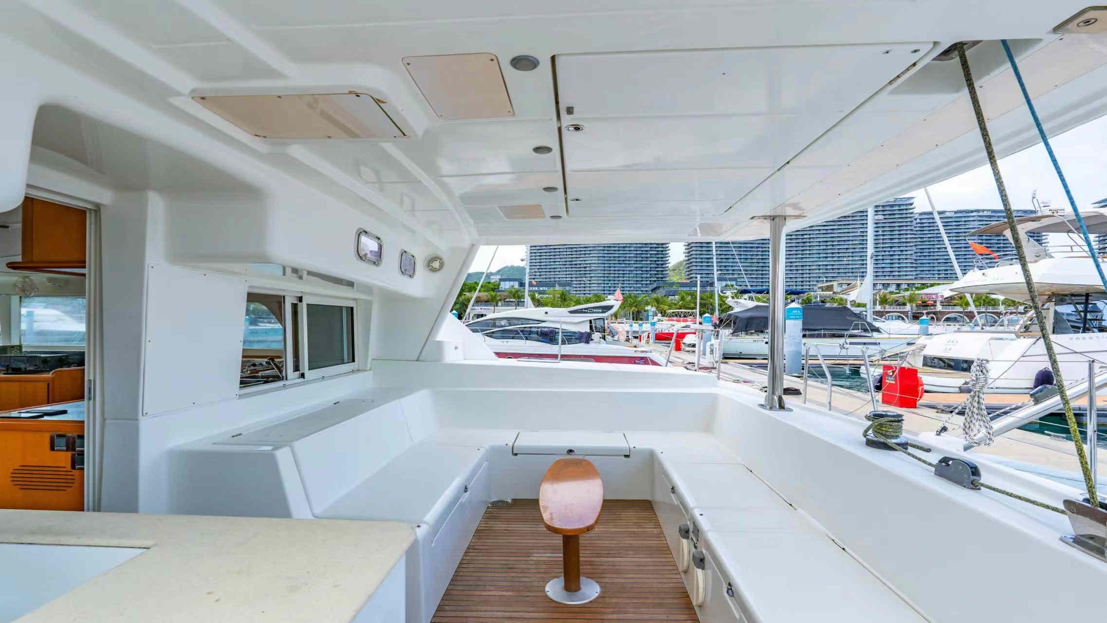 2007 Lagoon 440 yacht interior with spacious seating and modern design at a marina.