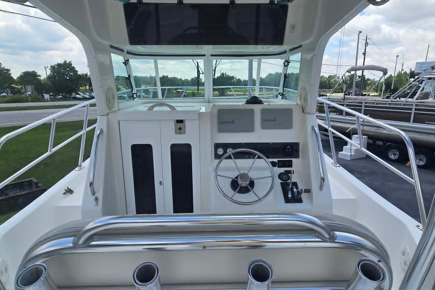 2003 True World Marine 286 boat cockpit with steering wheel and control panel.