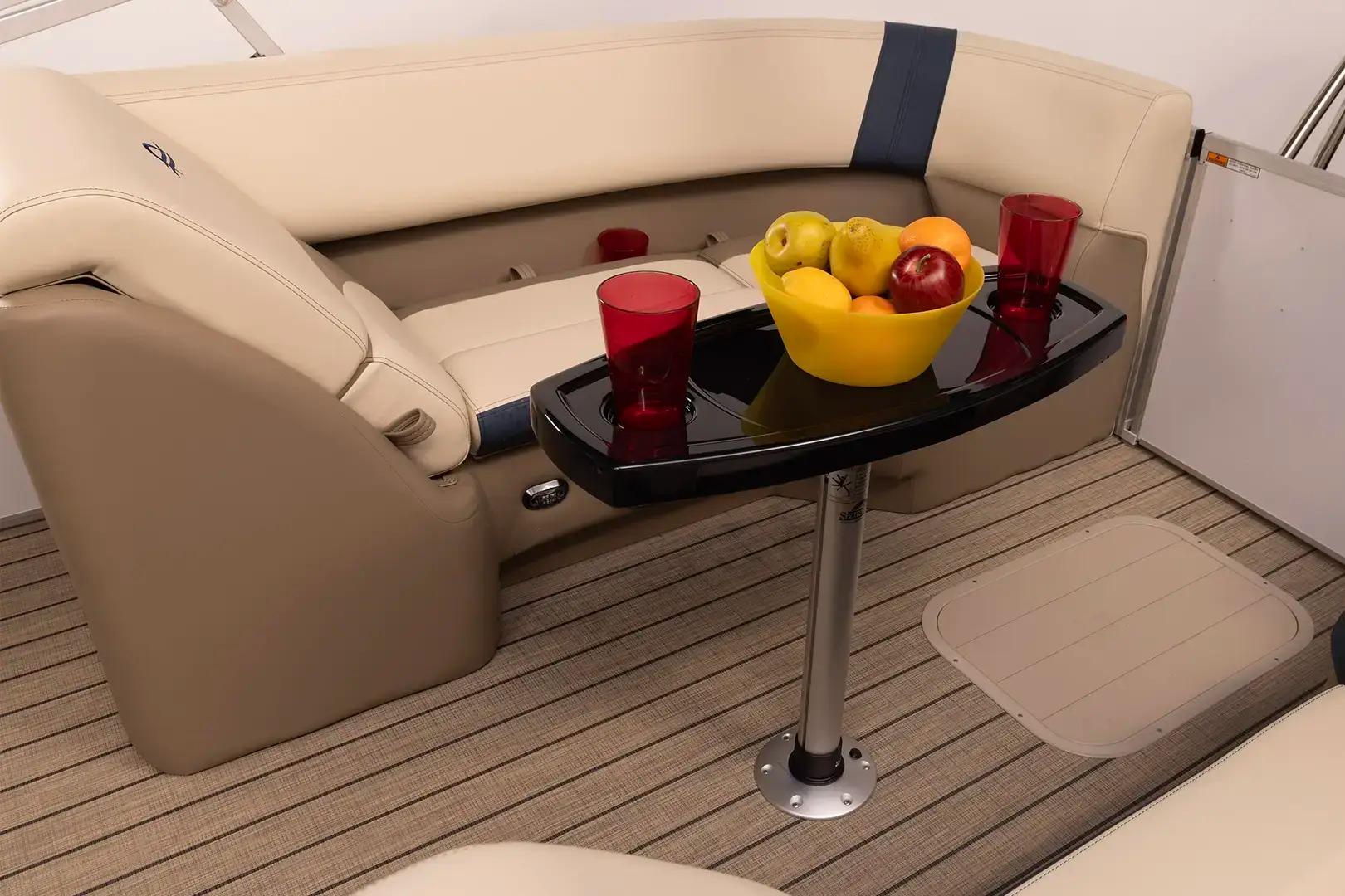 Manufacturer Provided Image: Luxurious seating area on 2026 SunCatcher Select 322RC boat with table and fruit bowl.