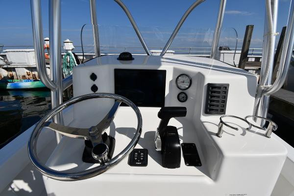 2021 Eastern 248 Center Console boat helm with steering wheel and control panel.