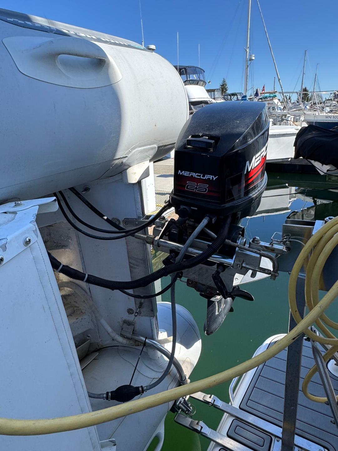 Outboard motor on a 2003 Meridian 381 Sedan yacht at a marina.