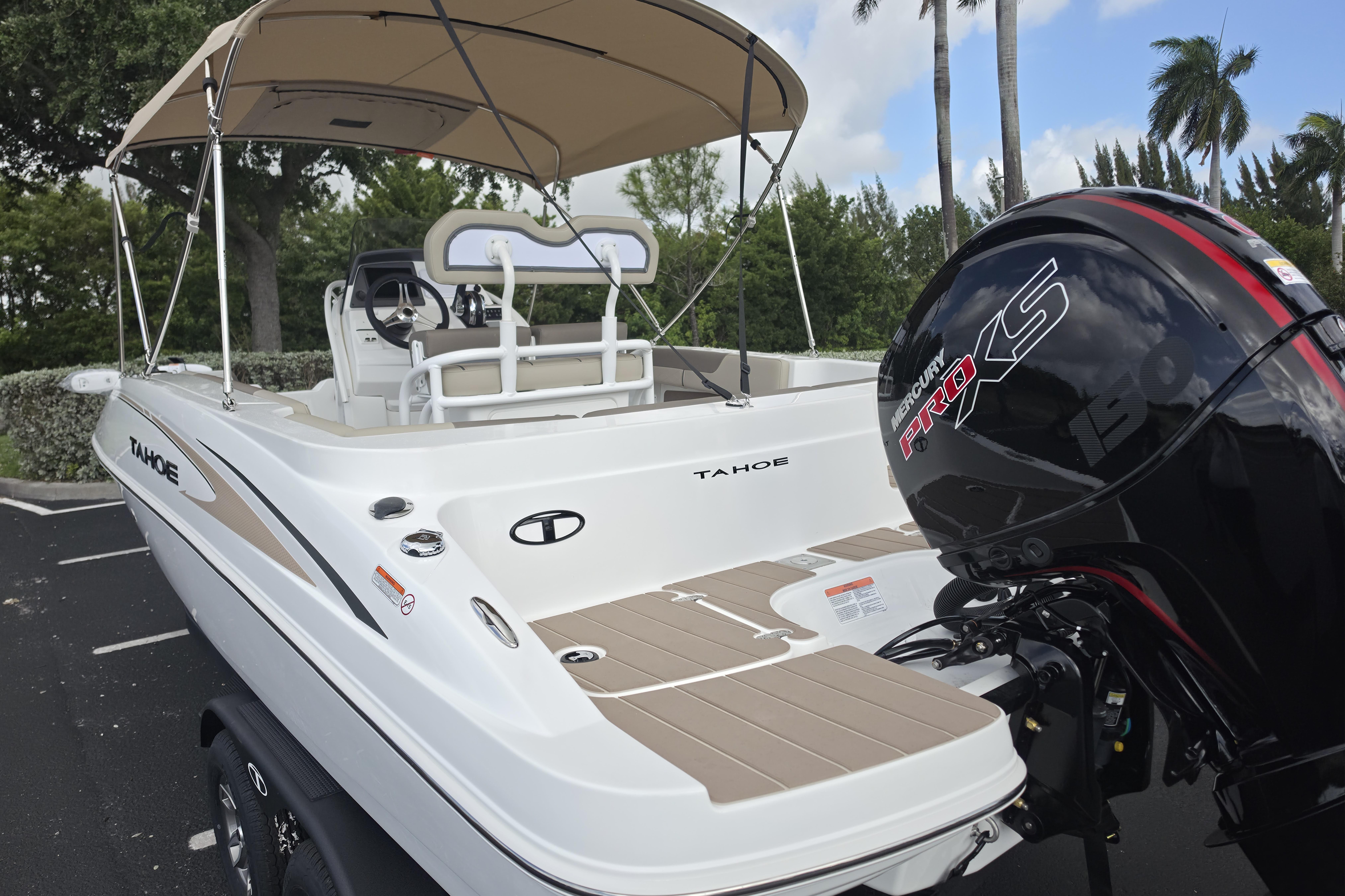 2026 Tahoe 2150 CC boat with Mercury Pro XS engine, parked outdoors under a canopy.