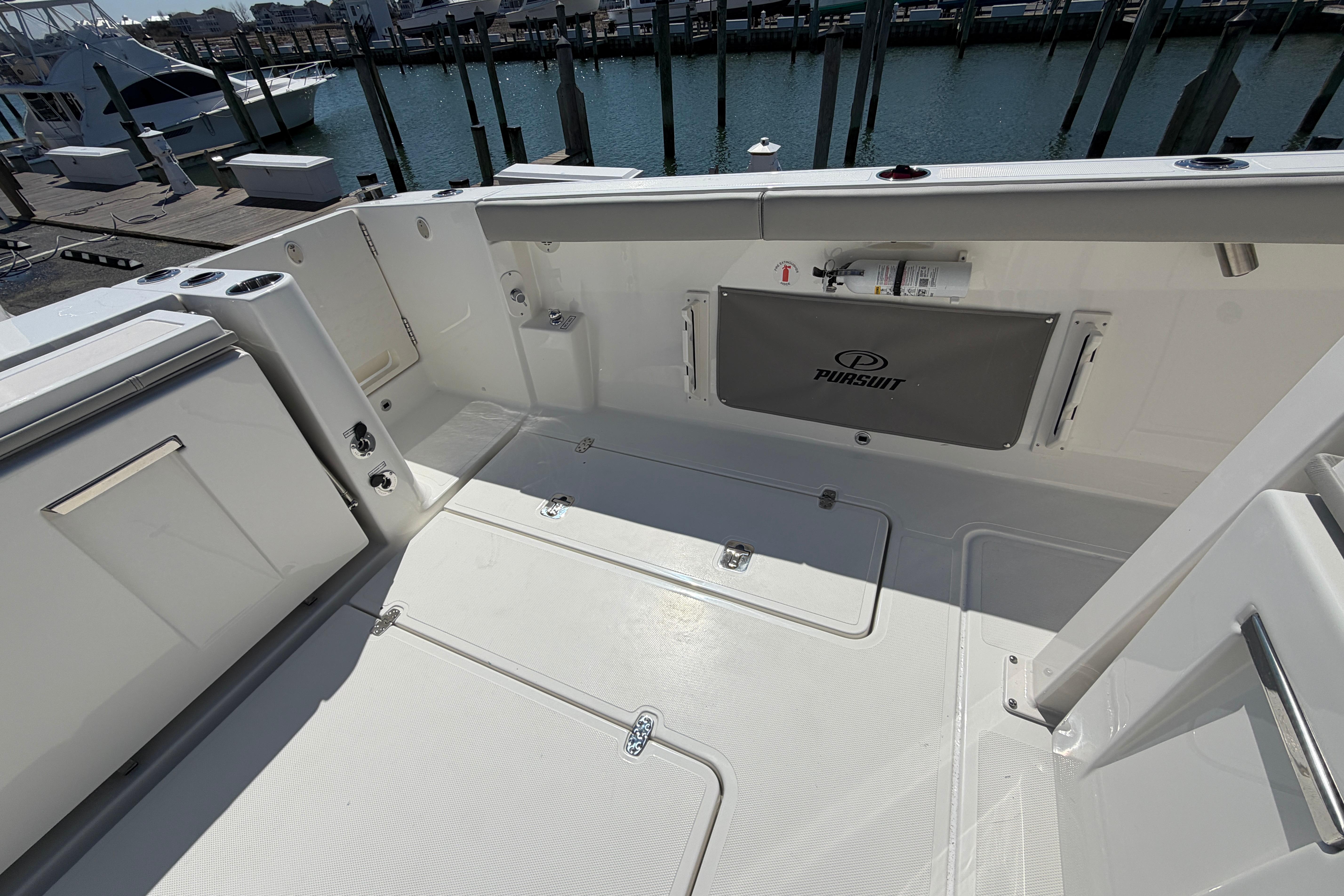 Spacious deck of 2026 Pursuit S 358 Sport boat at marina.