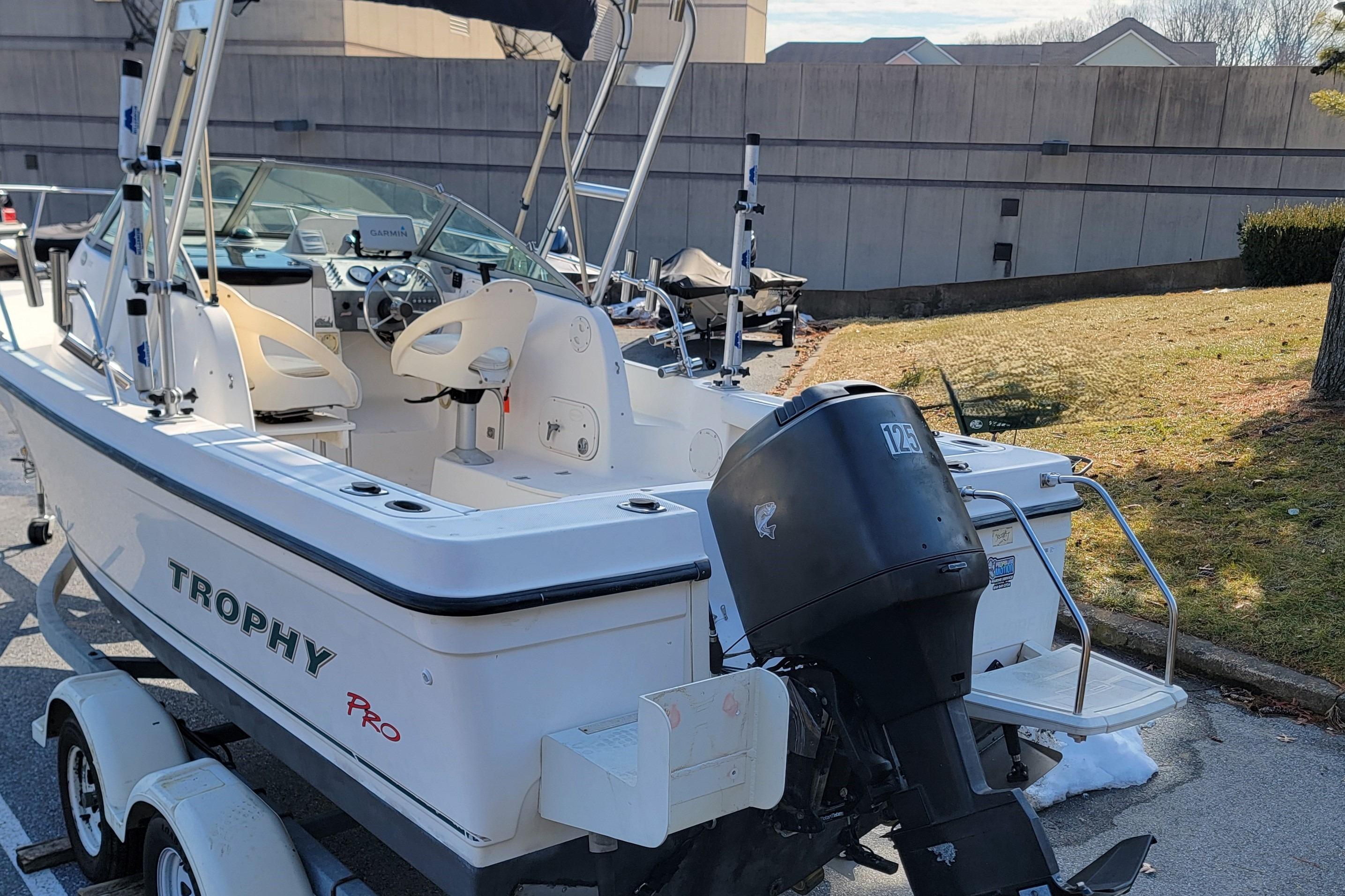 2003 Trophy 2002 Walkaround boat with outboard motor, parked on a trailer.