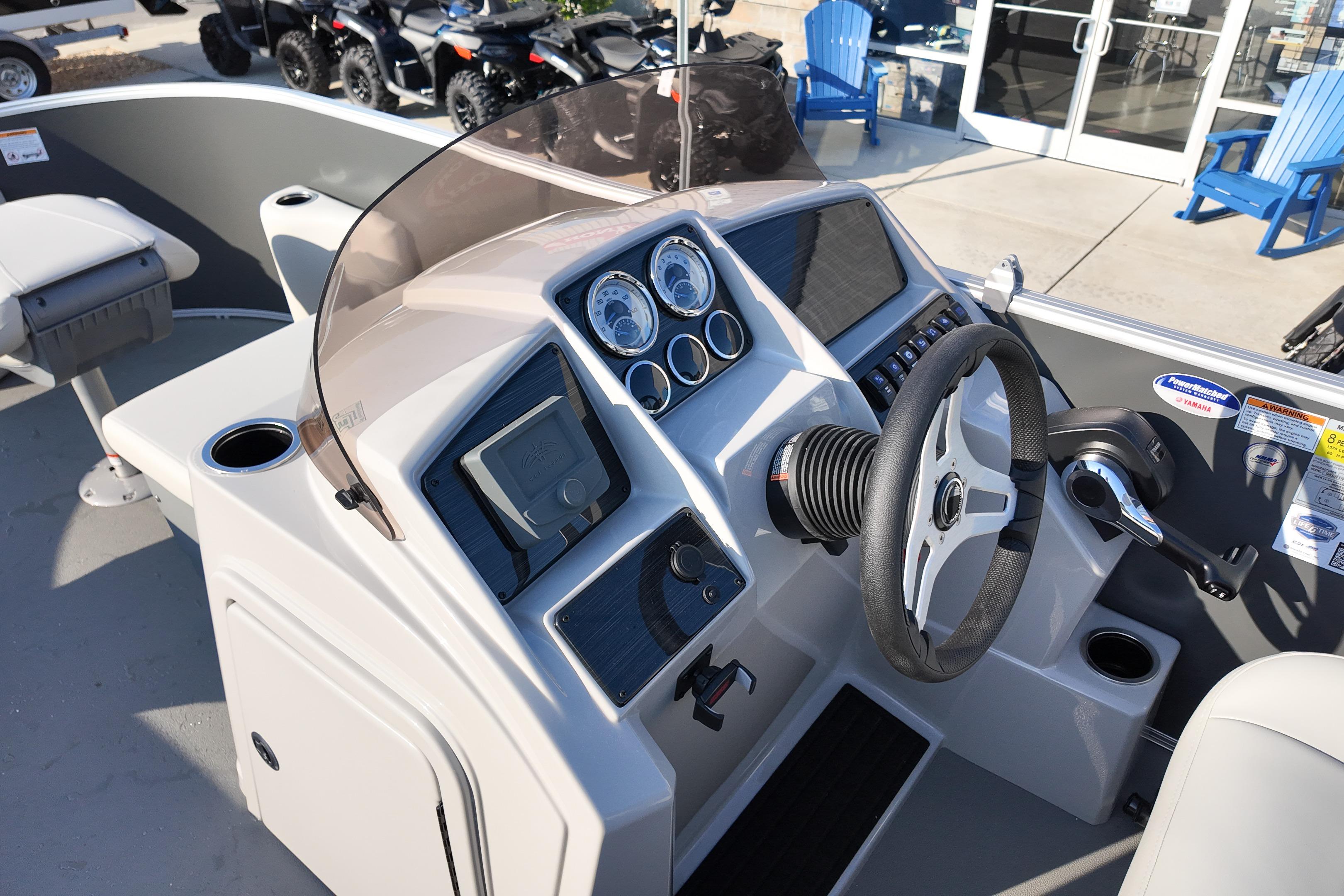 2026 Sylvan Mirage 818 Fish boat dashboard with steering wheel and control panel.
