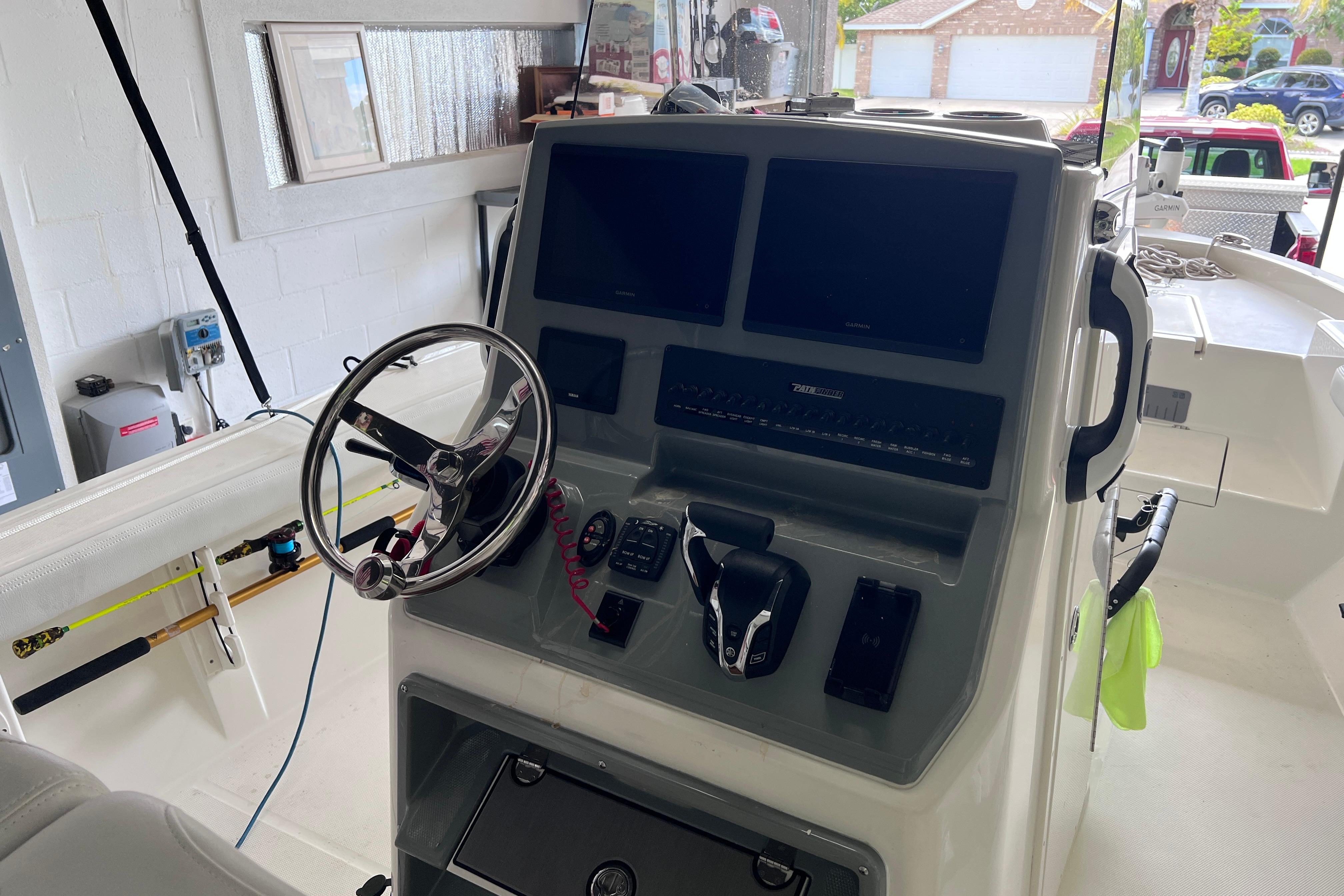 2024 Pathfinder 2400 Open boat dashboard with steering wheel and electronic controls.