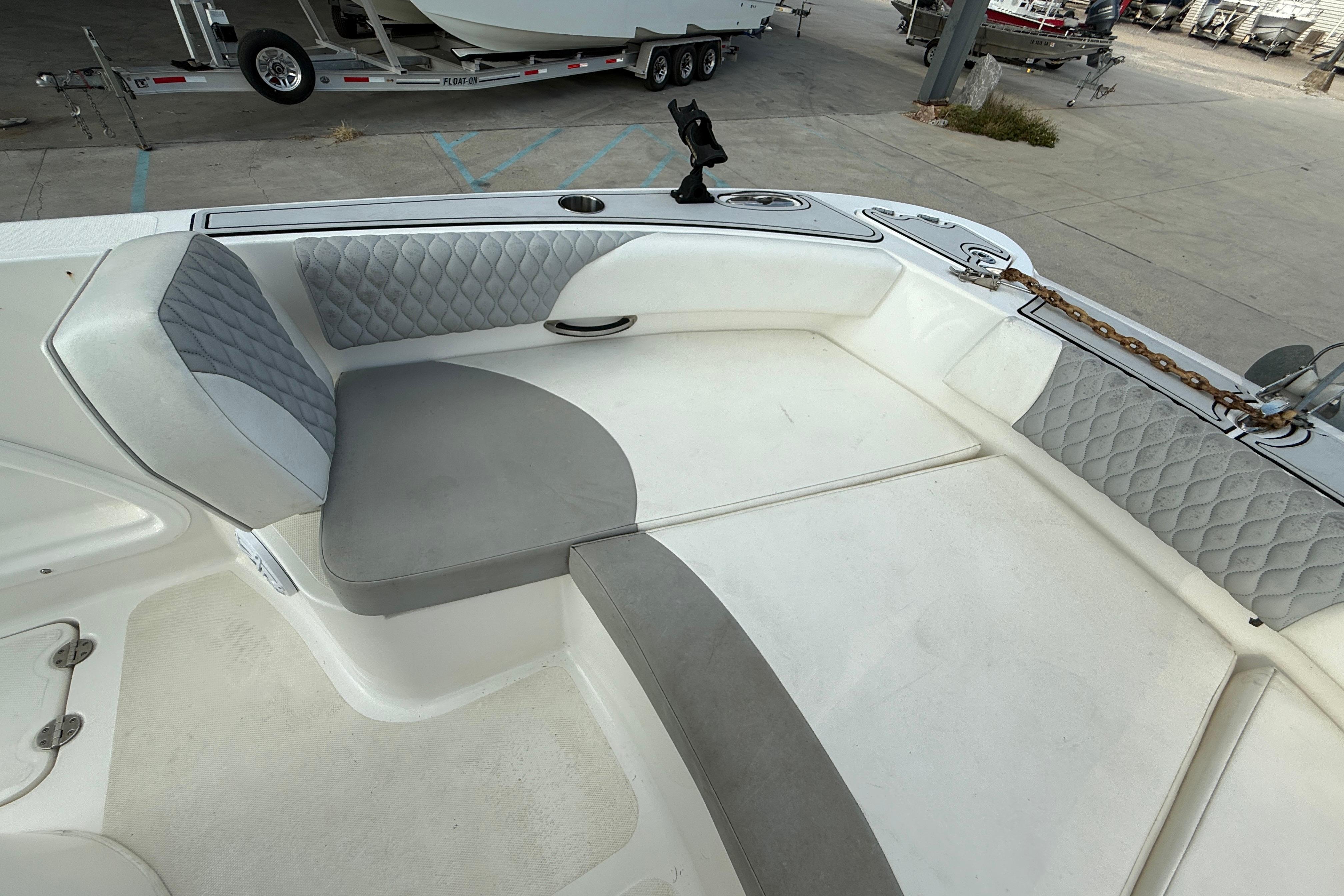 2020 Twin Vee 240 GFX CC boat interior with cushioned seating and storage.