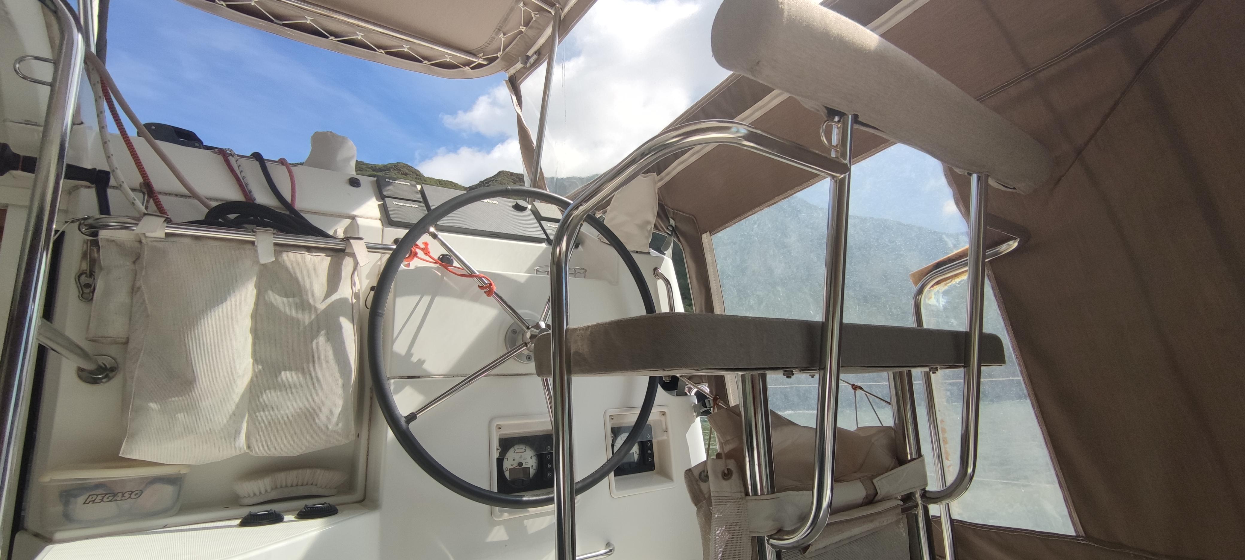 Cockpit of 2014 Lagoon 39 catamaran with steering wheel and seating.