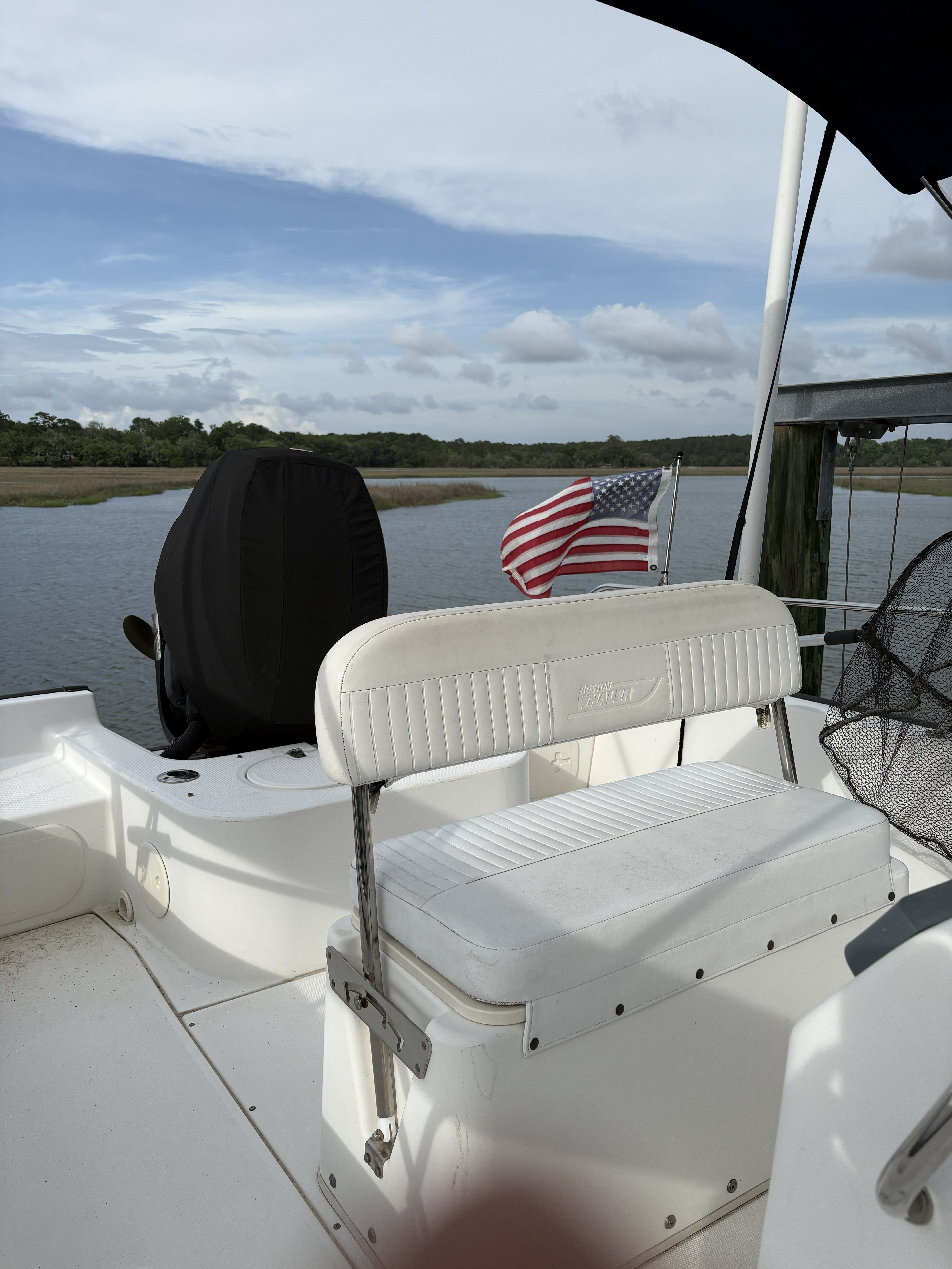 Boston Whaler 190 Montauk 2012 with American flag on calm waters.