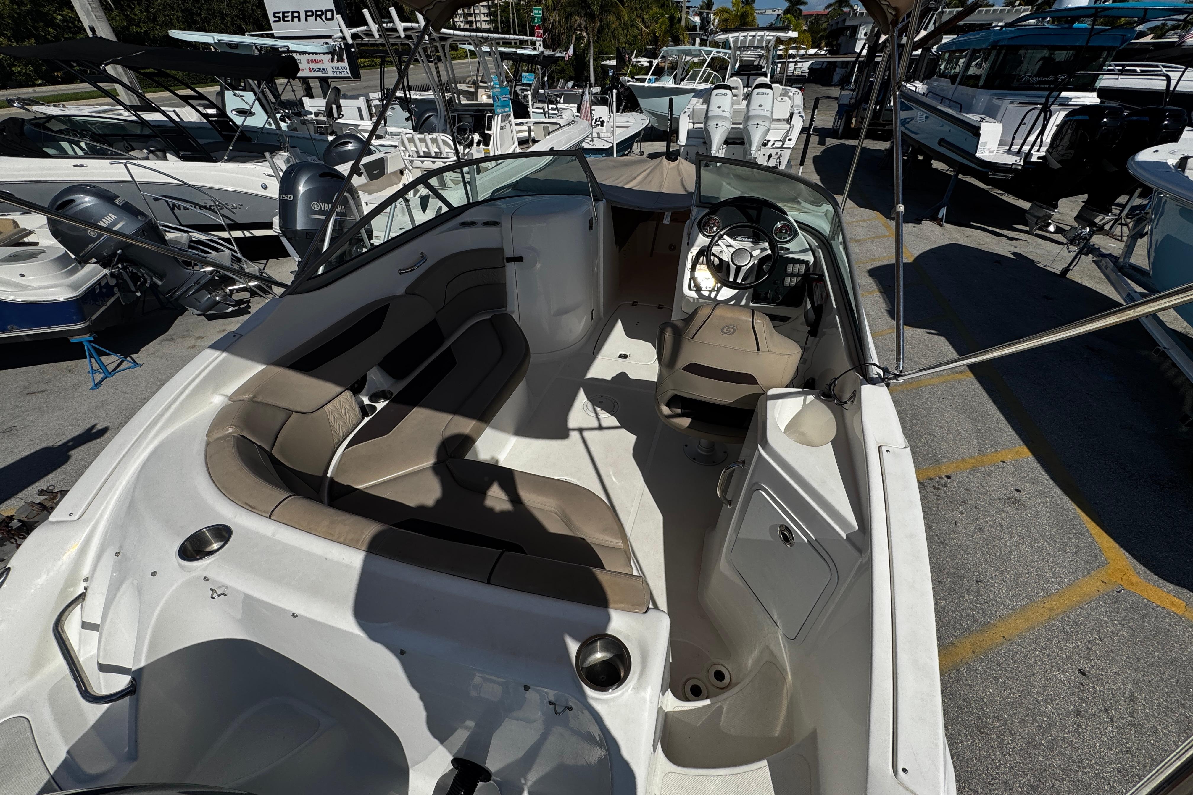 2021 Hurricane SunDeck 2200 DC OB boat interior with seating and steering console.