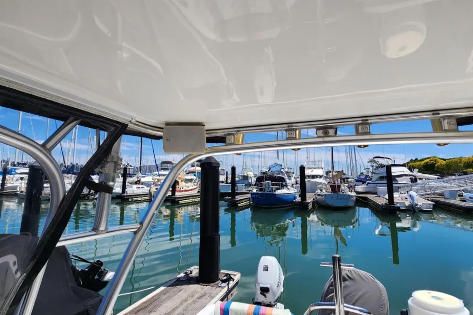 Boston Whaler 21 Conquest 2000 at marina, surrounded by boats and clear blue sky.