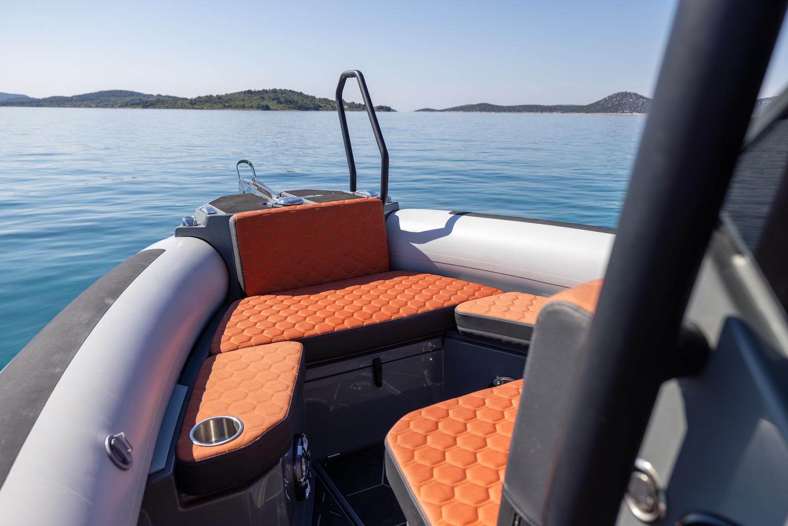 2026 Highfield ADV 7 boat with orange seating on calm water.