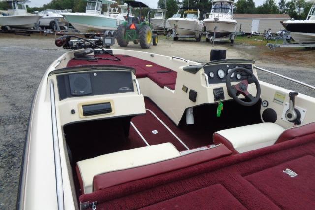 1996 Quantum 180 XD boat with maroon interior, parked among other boats.