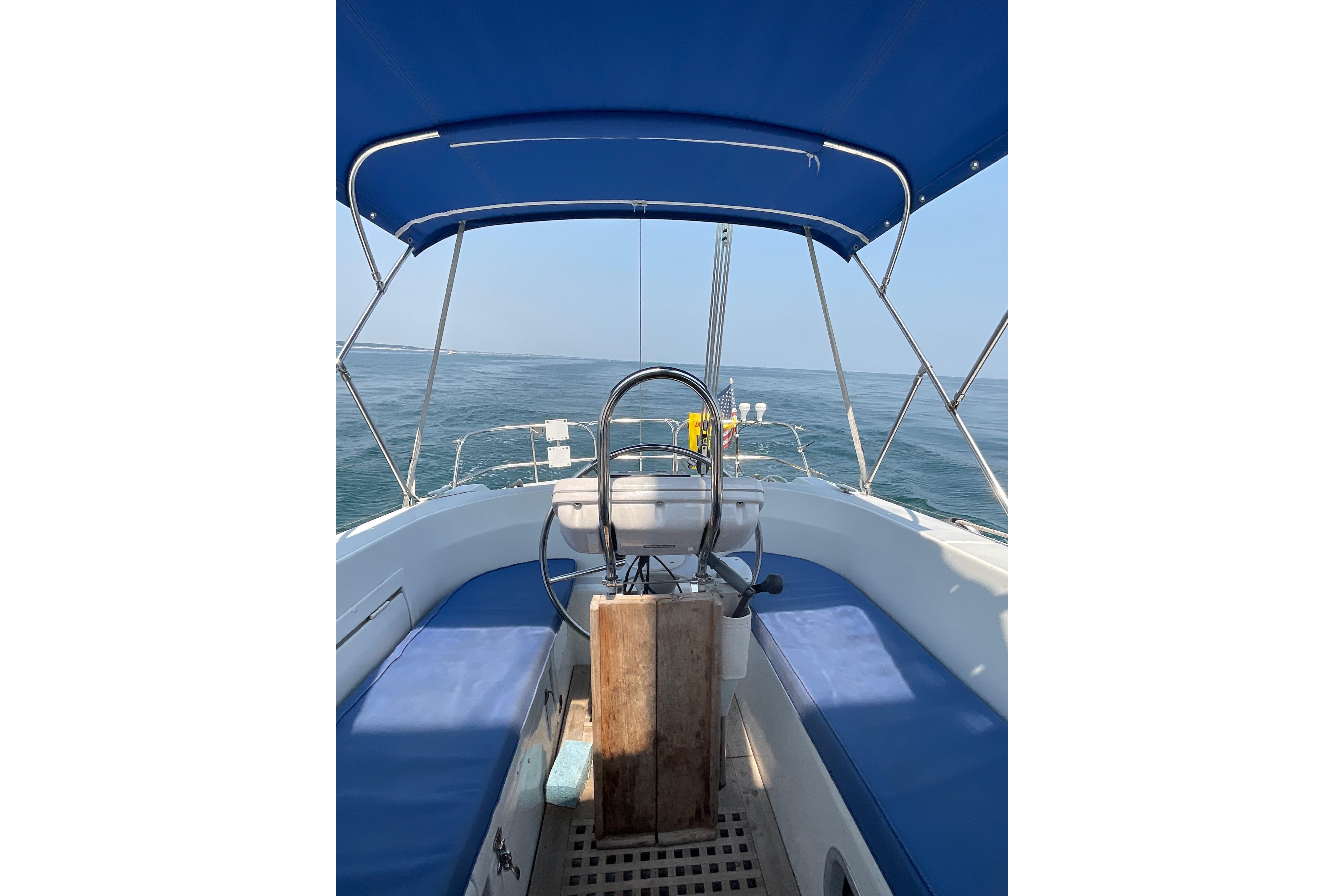 Cockpit view of 1988 Westerly Corsair 36 sailboat with blue canopy on open sea.