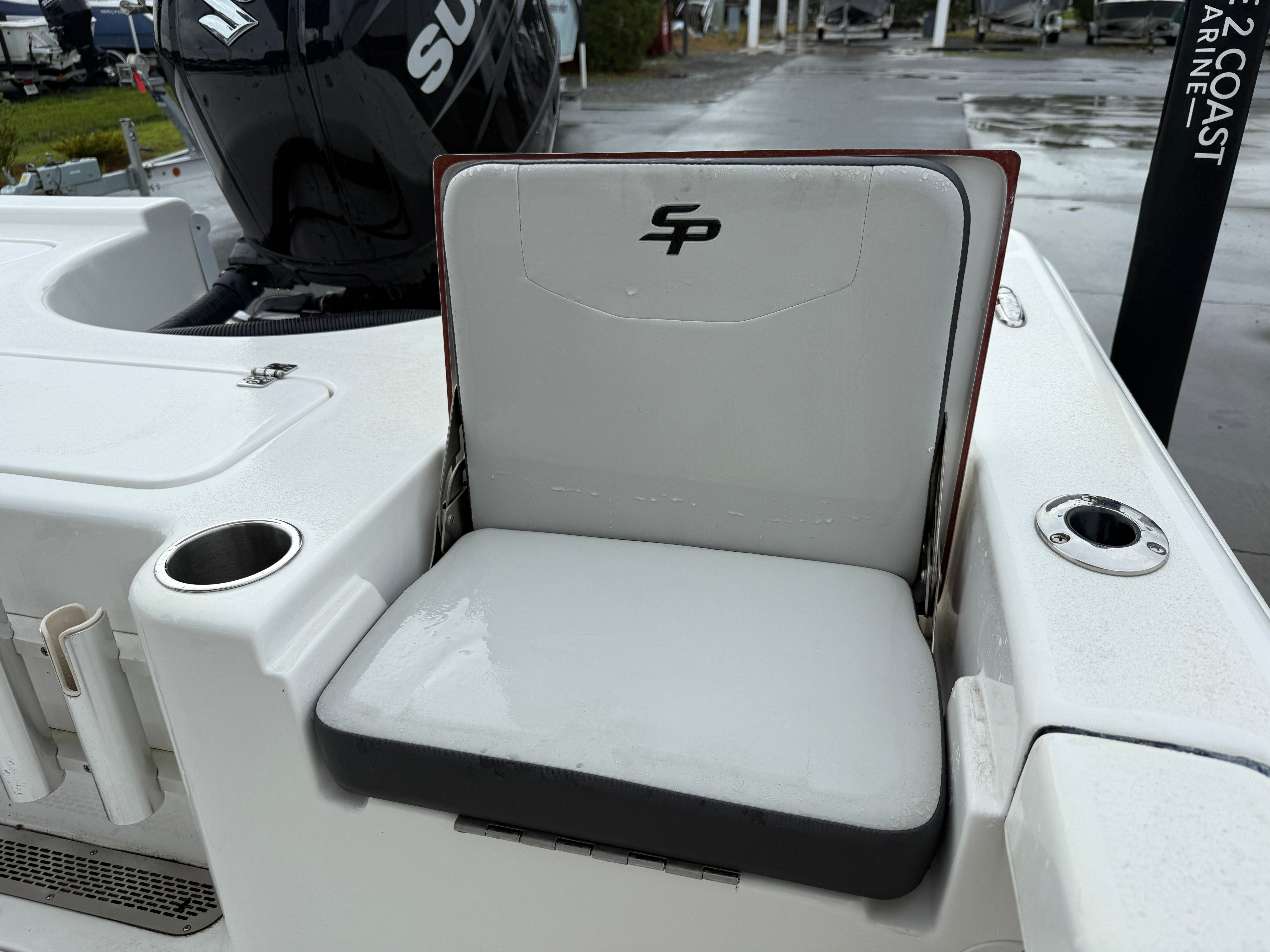 A seat on a Sea Pro 230 DLX boat with a Suzuki engine in the background.