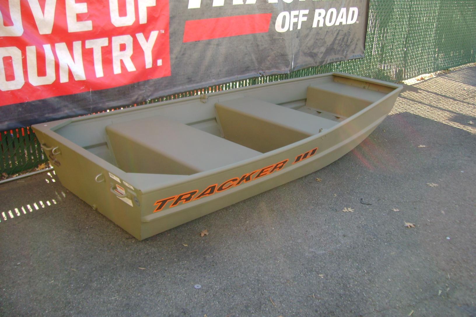 2026 Tracker Grizzly 10 Jon boat displayed outdoors, featuring durable design and off-road branding.
