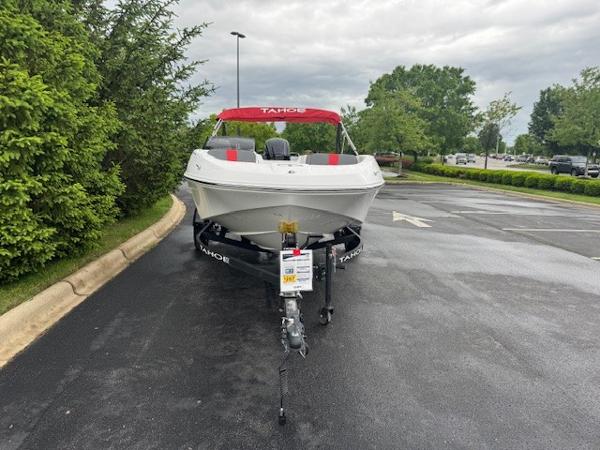 2025 Tahoe T16 boat with red canopy on a trailer in a parking lot.