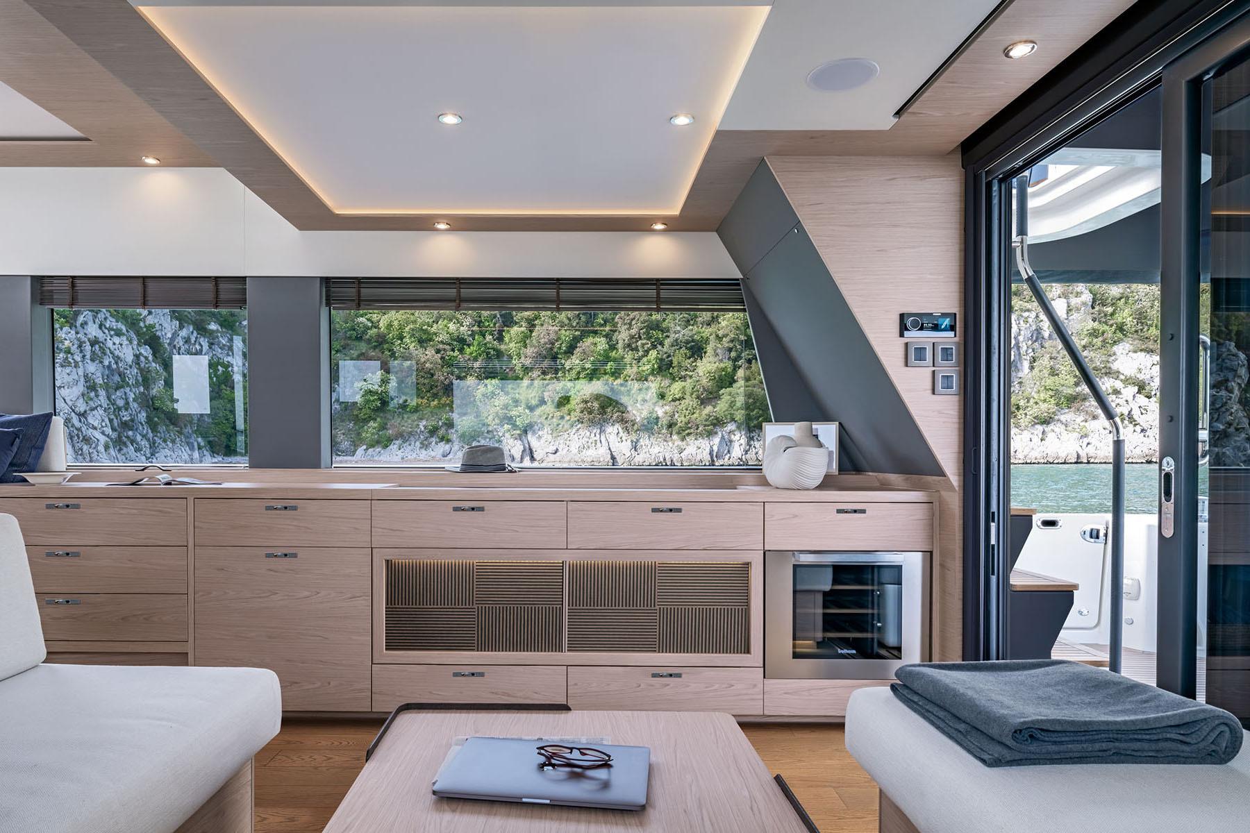 Manufacturer Provided Image: Luxurious interior of 2025 Beneteau Grand Trawler 63 with modern design and scenic window view.
