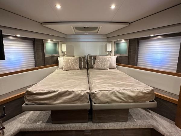Luxurious bedroom interior of 2019 Tiara Yachts C53 with twin beds and modern lighting.