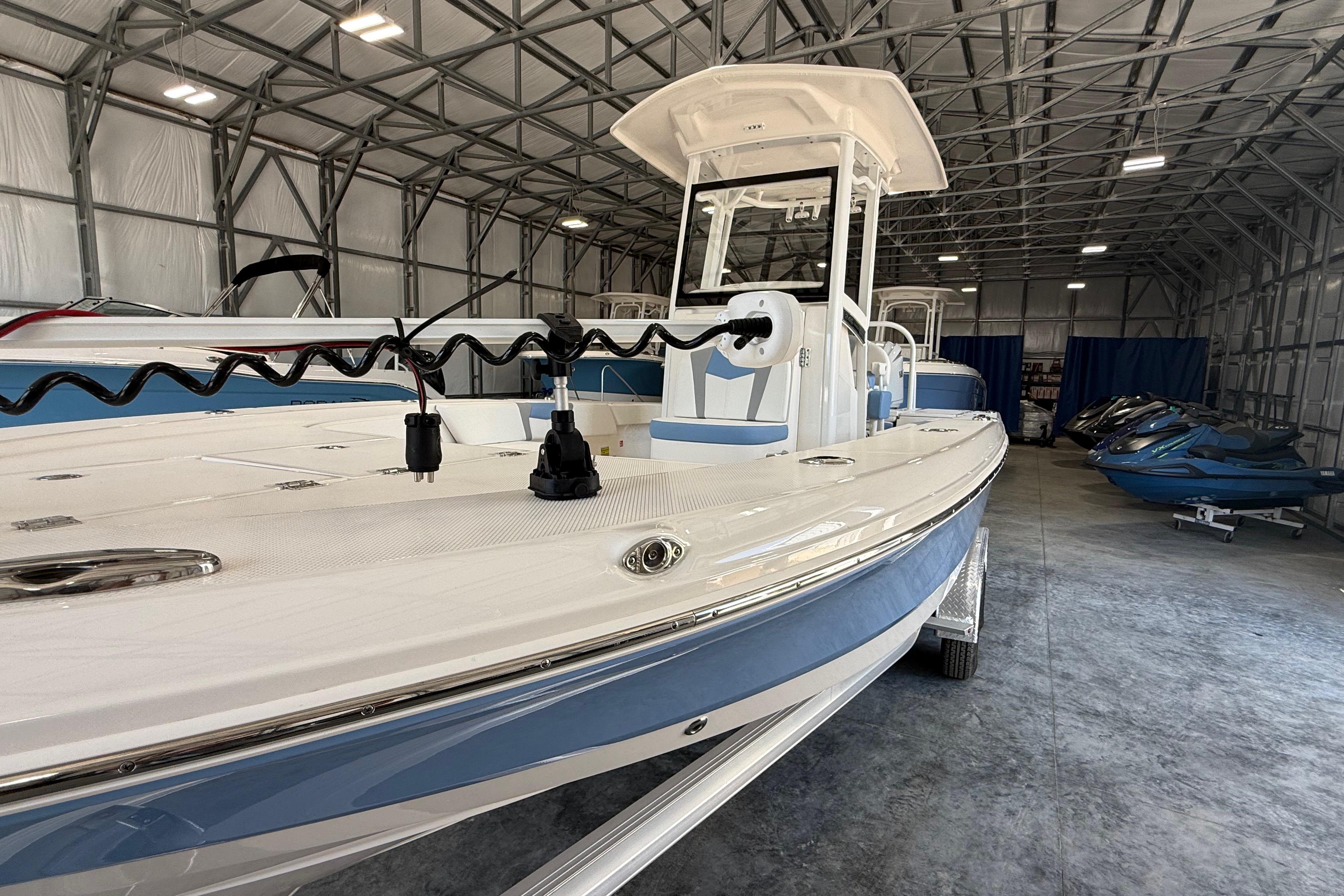 2026 Robalo 246 Cayman boat in a spacious indoor storage facility.