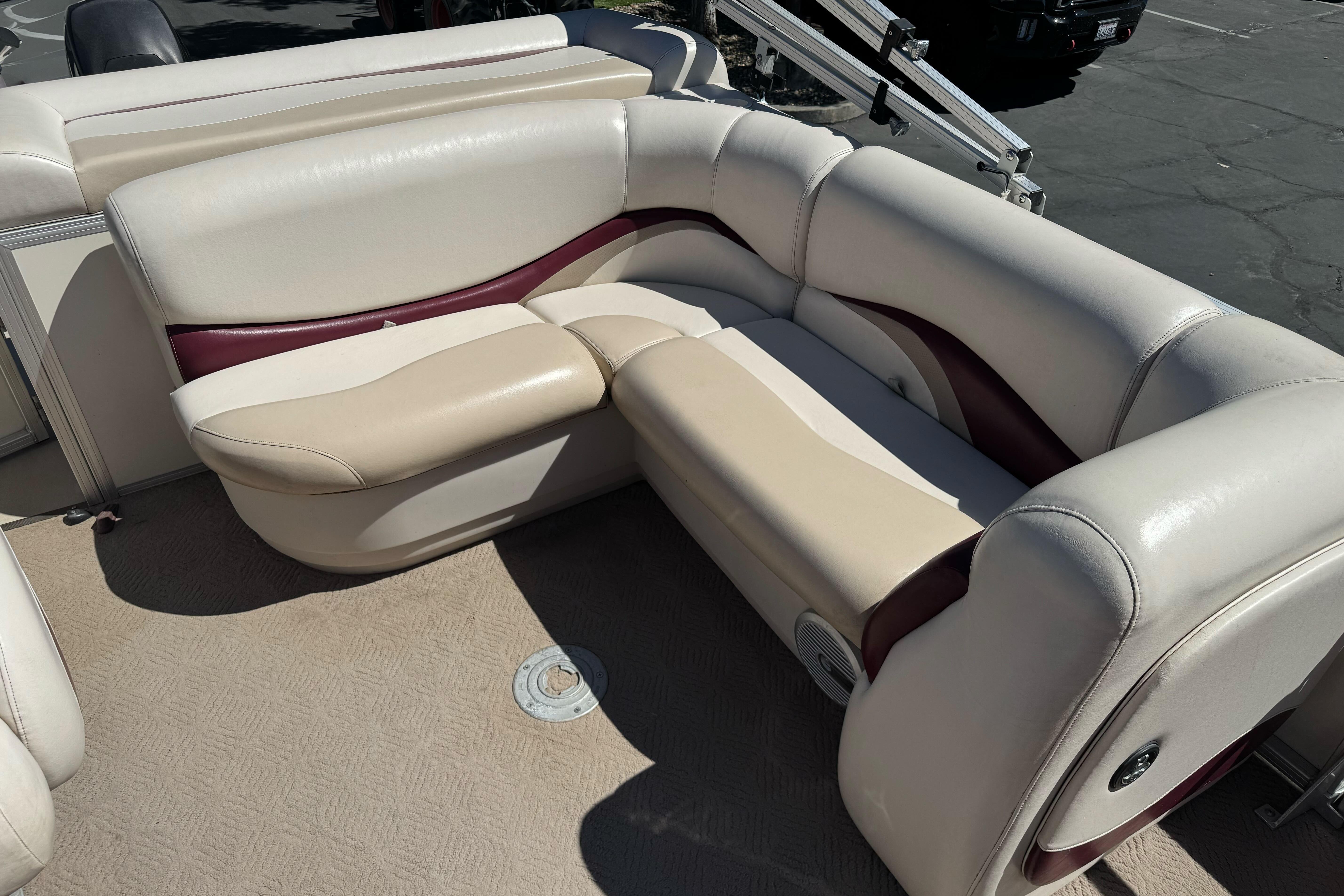 2011 Sun Tracker Party Barge 21 interior with beige and maroon seating.