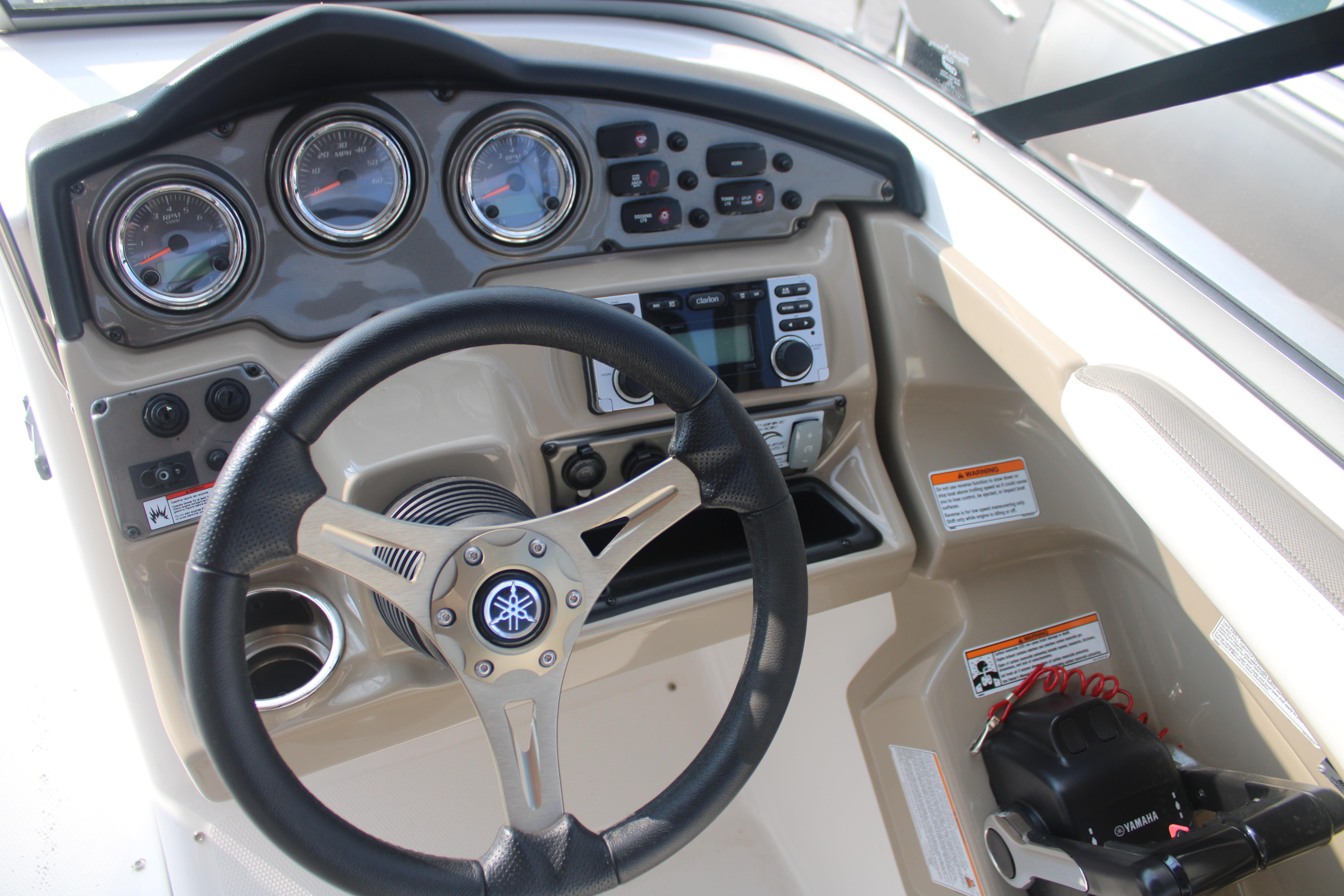 2013 Yamaha Boats 242 Limited S dashboard with steering wheel and control panel.