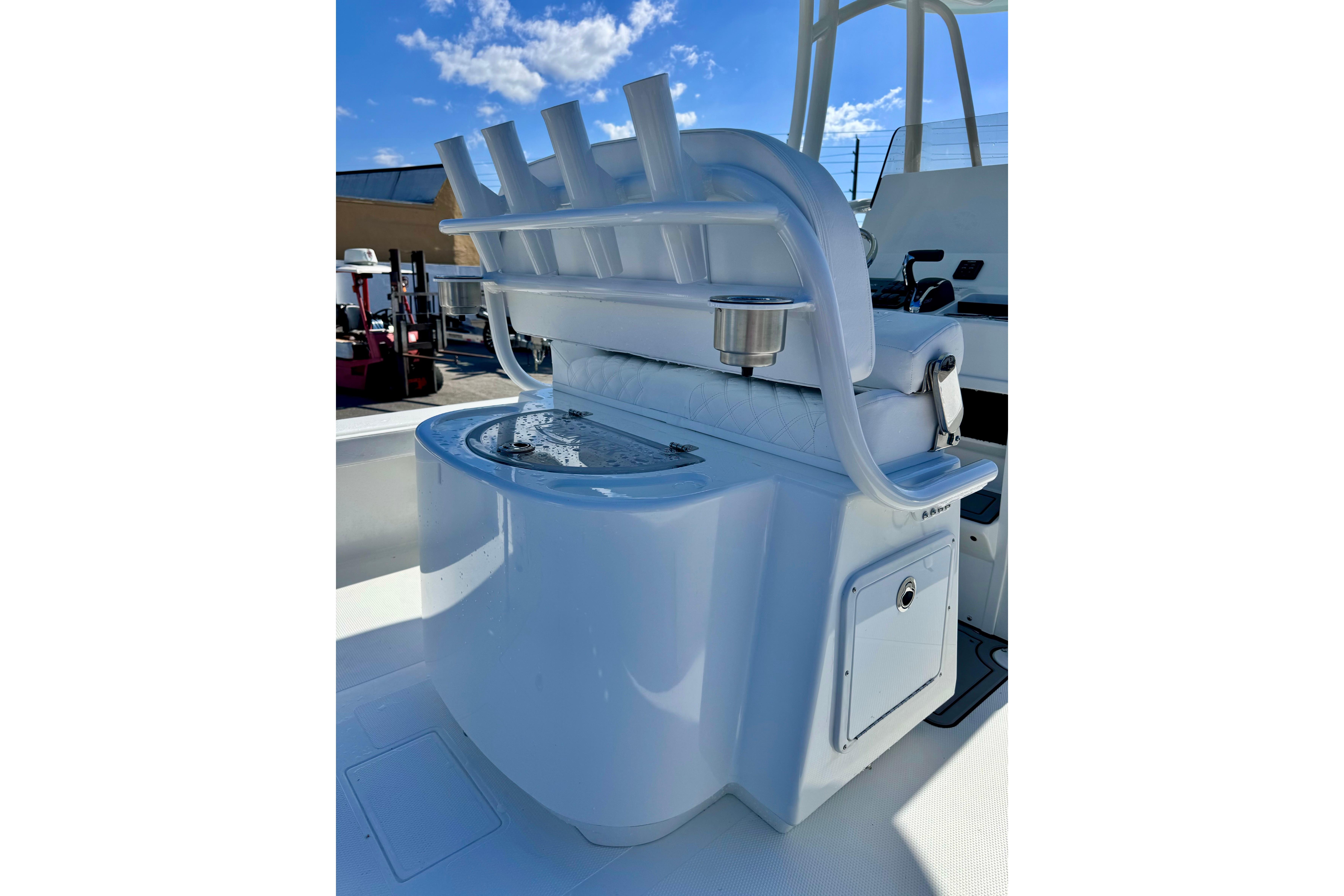 2026 BlackJack 256 Coastal boat interior with rod holders and seating under a clear blue sky.