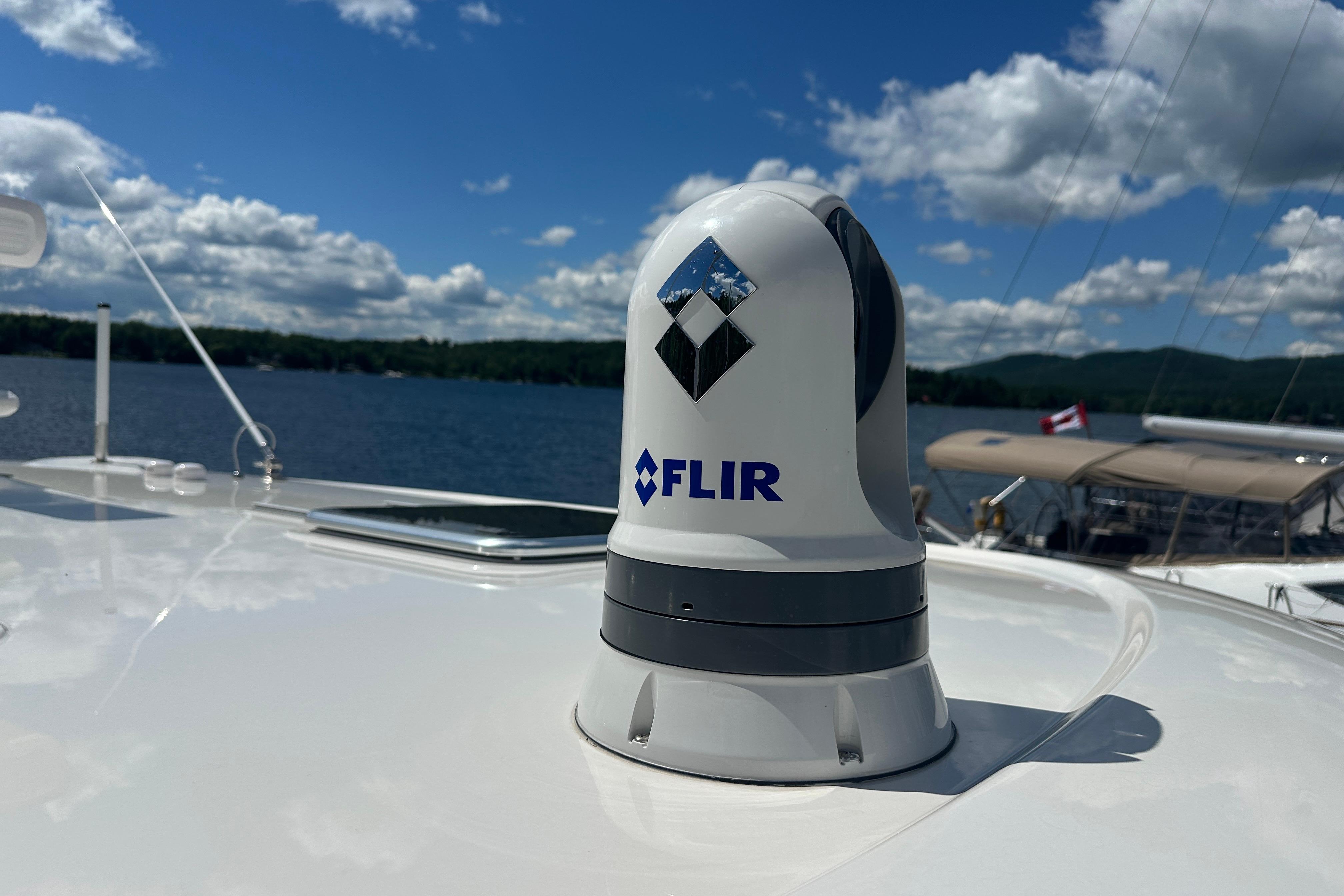 FLIR camera on 2025 Sabre 48 Salon Express yacht under clear blue sky.