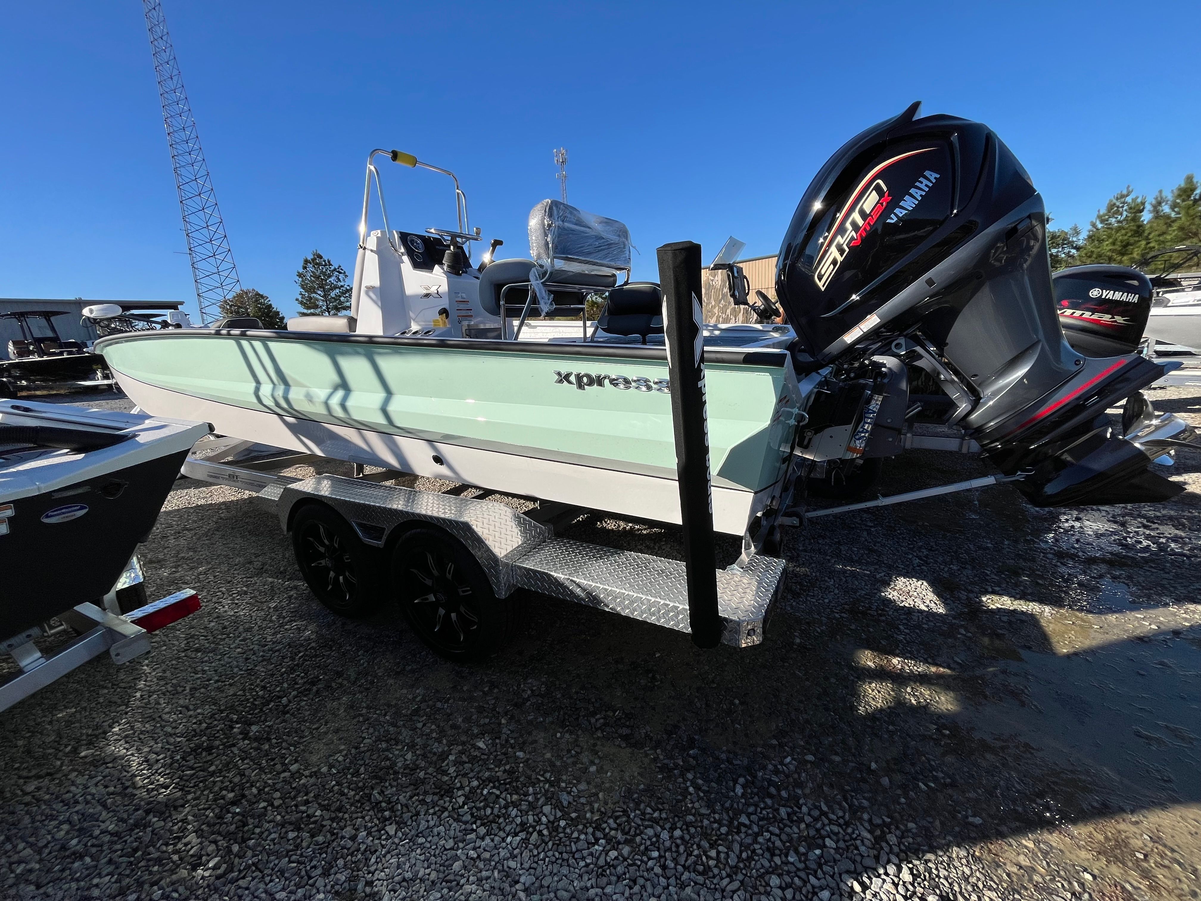 2024 Xpress X23B Bay Lounge boat on trailer.
