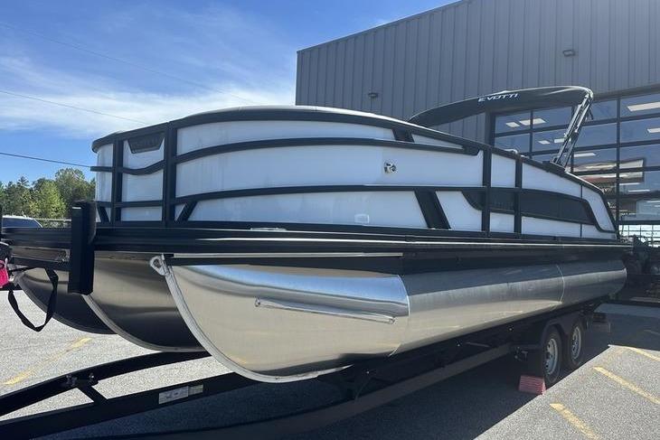 2026 Evotti 523QL pontoon boat on trailer, parked outside a building.