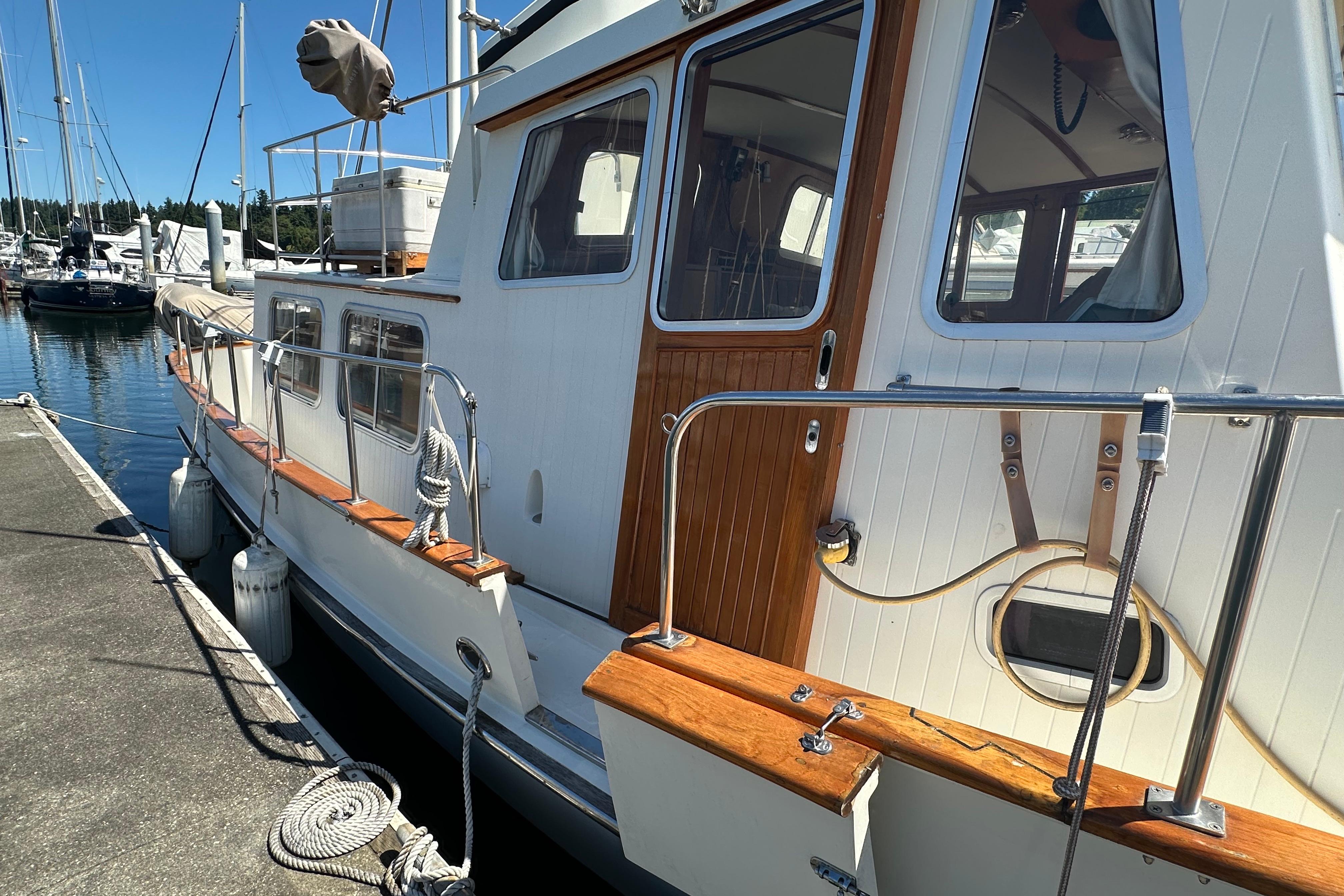 Eagle 40 Pilothouse Trawler 2000 docked, showcasing wooden accents and sleek design.